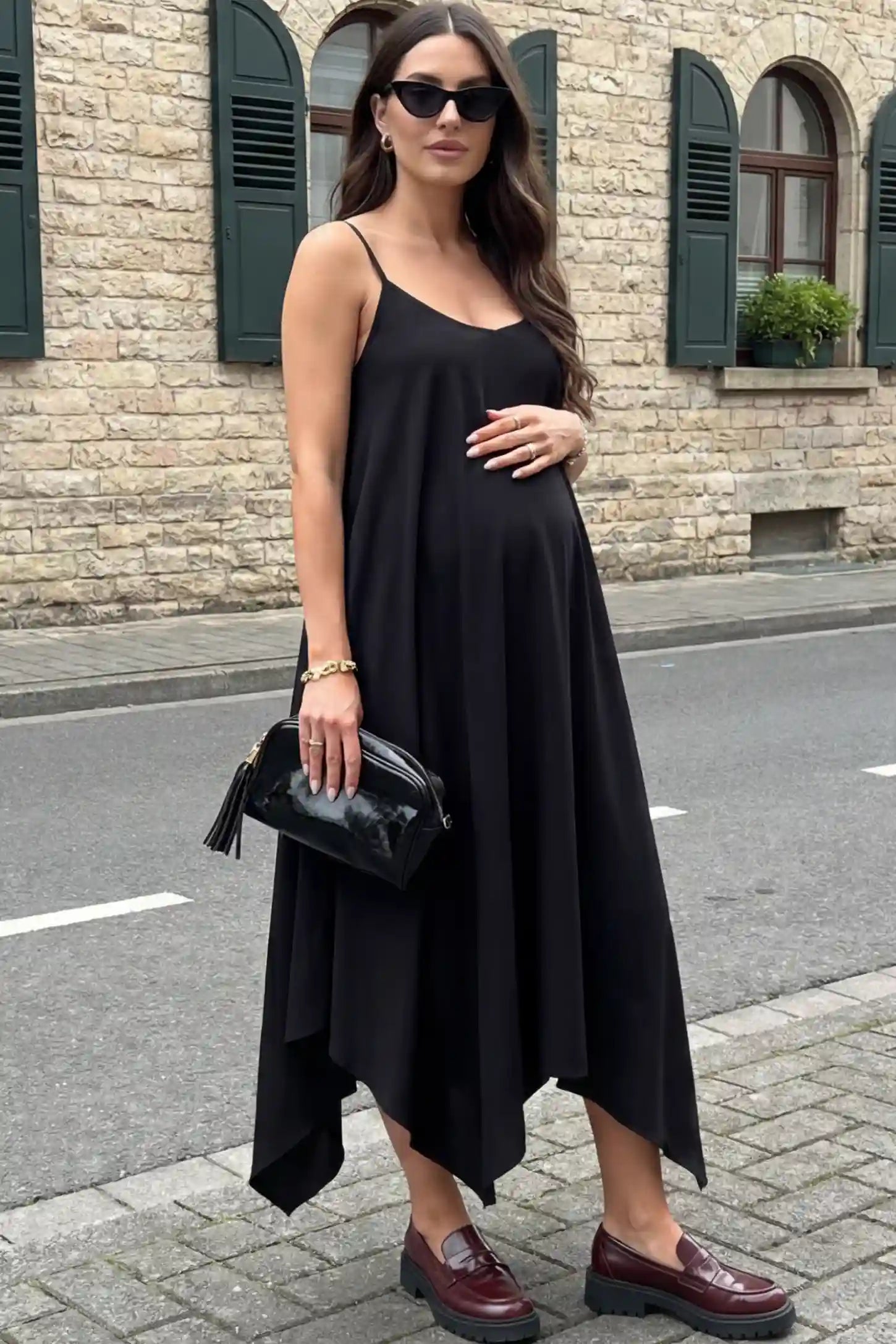 Spaghetti Strap Handkerchief Hem Maternity Midi Dress in Black featuring a scoop-neck on a pregnant model.