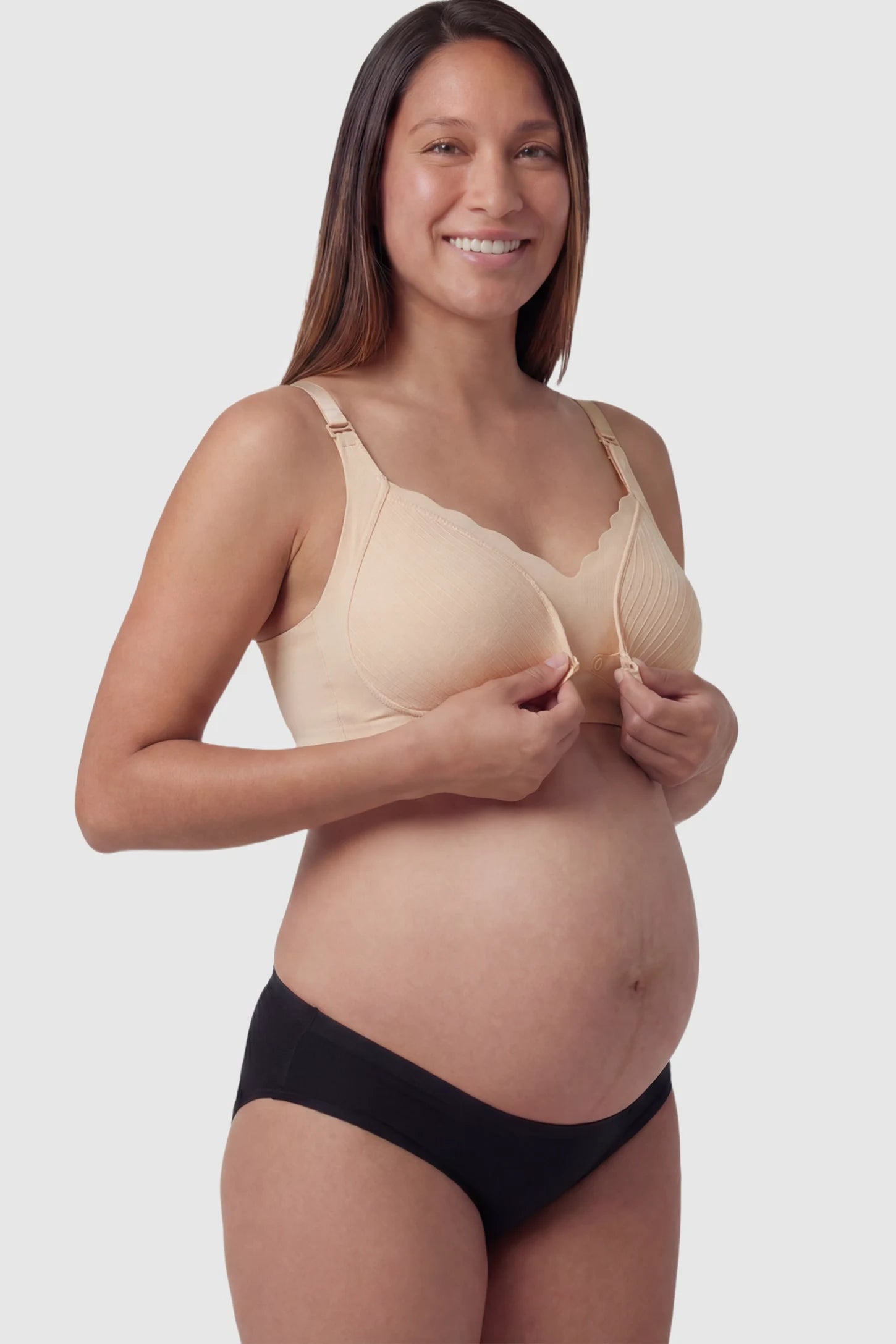 Textured Wire Free Front Snap Maternity Nursing Bra Textured Wire-Free Front-Snap Maternity Nursing Bra in Skin Tone featuring breathable ribbed fabric on a pregnant model.