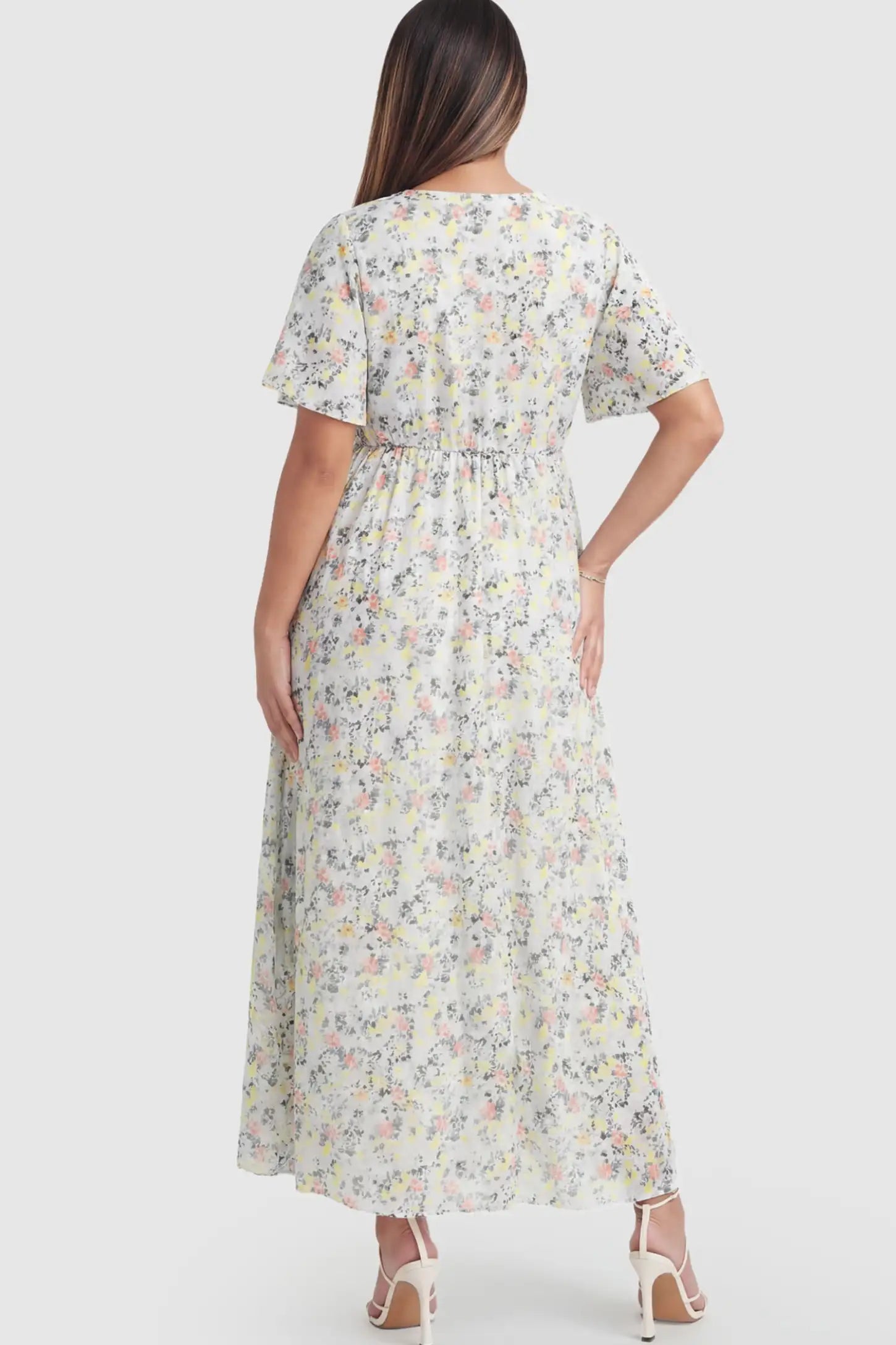 Floral V-Neck Side-Slit Maternity Maxi Dress Floral V-Neck Side-Slit Maternity Maxi Dress in white on a pregnant model.