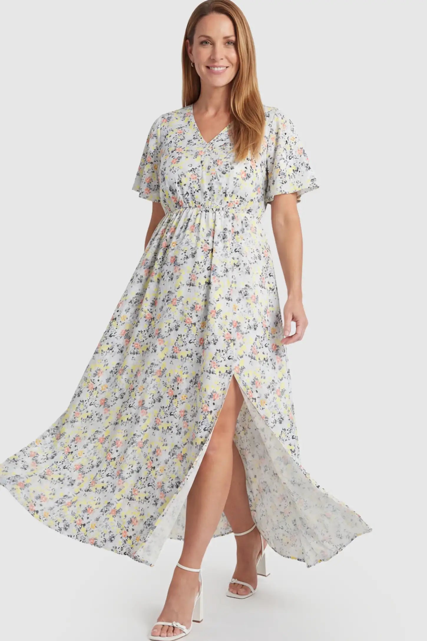 Floral V-Neck Side-Slit Maternity Maxi Dress Floral V-Neck Side-Slit Maternity Maxi Dress in white on a postpartum model.