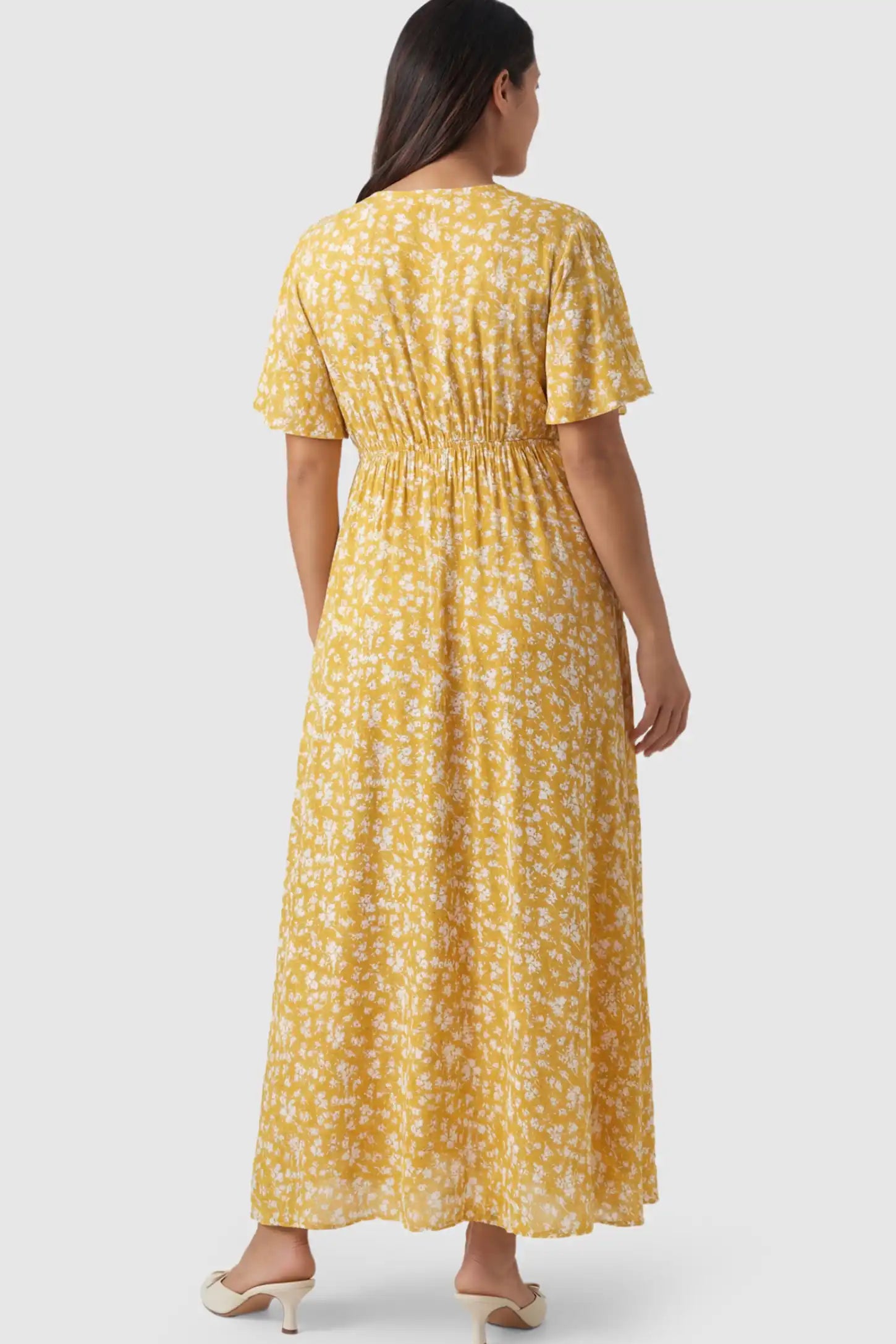 Floral V-Neck Side-Slit Maternity Maxi Dress Floral V-Neck Side-Slit Maternity Maxi Dress in yellow on a pregnant model.