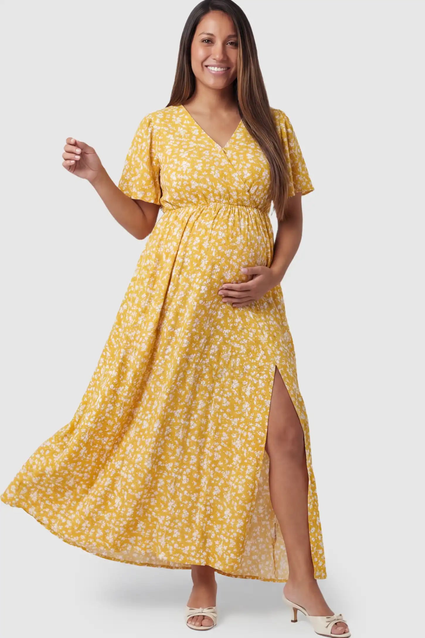 Floral V-Neck Side-Slit Maternity Maxi Dress Floral V-Neck Side-Slit Maternity Maxi Dress in yellow on a pregnant model.