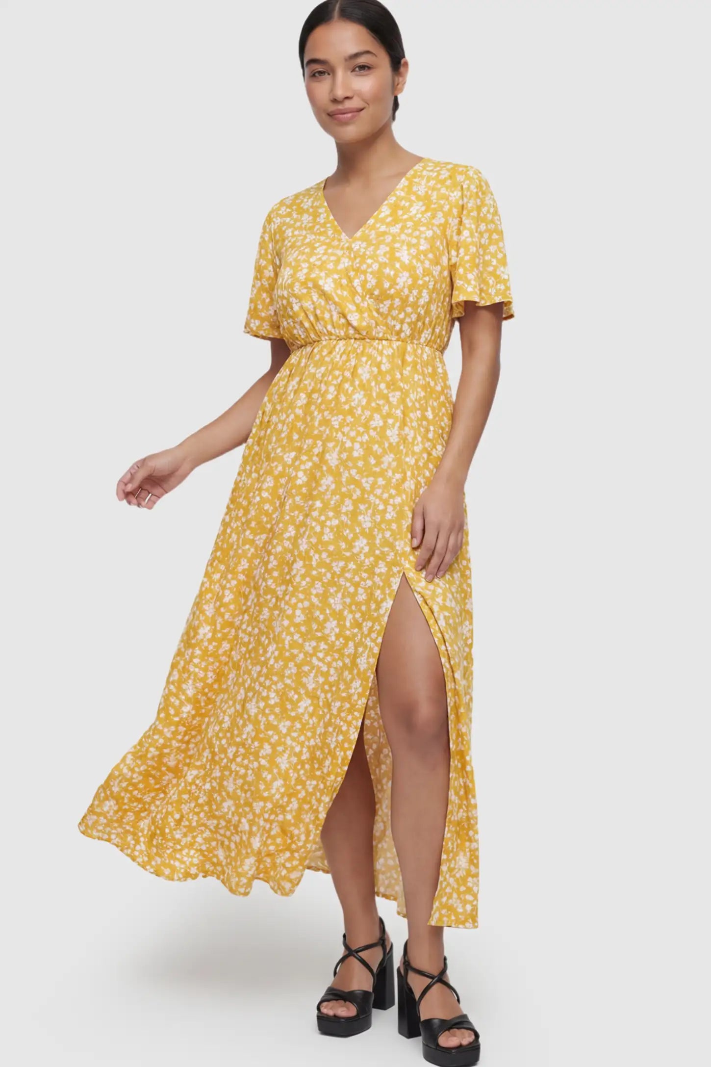 Floral V-Neck Side-Slit Maternity Maxi Dress Floral V-Neck Side-Slit Maternity Maxi Dress in yellow on a postpartum model.
