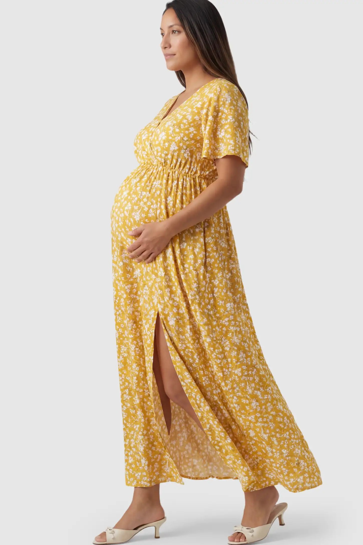 Floral V-Neck Side-Slit Maternity Maxi Dress Floral V-Neck Side-Slit Maternity Maxi Dress in yellow on a pregnant model.