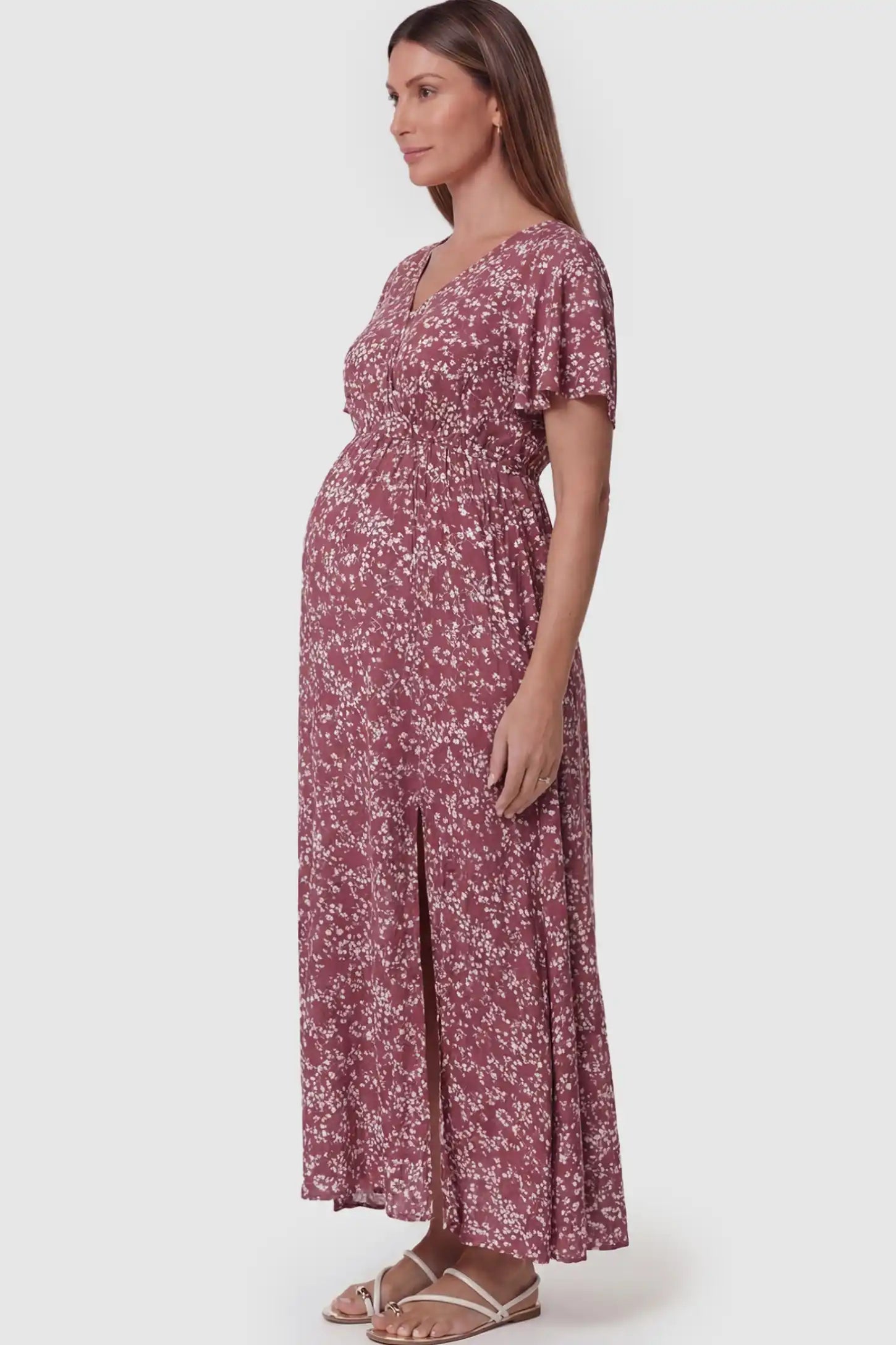 Floral V-Neck Side-Slit Maternity Maxi Dress Floral V-Neck Side-Slit Maternity Maxi Dress in pink on a pregnant model.