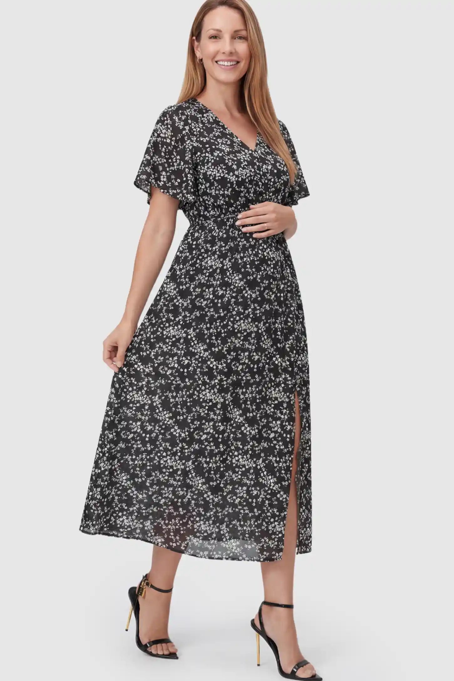 Floral V-Neck Side-Slit Maternity Maxi Dress Floral V-Neck Side-Slit Maternity Maxi Dress in black on a postpartum model.