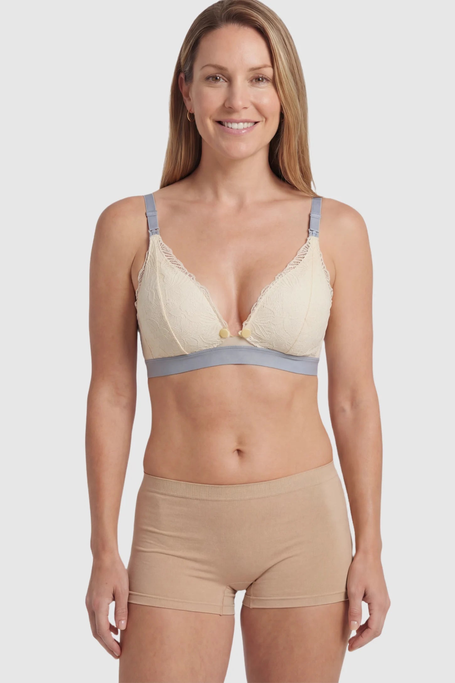 Floral Lace Front Button Maternity Nursing Bra Floral Lace Front Button Maternity Nursing Bra in Skin featuring a wide grey elastic underband on a postpartum model.