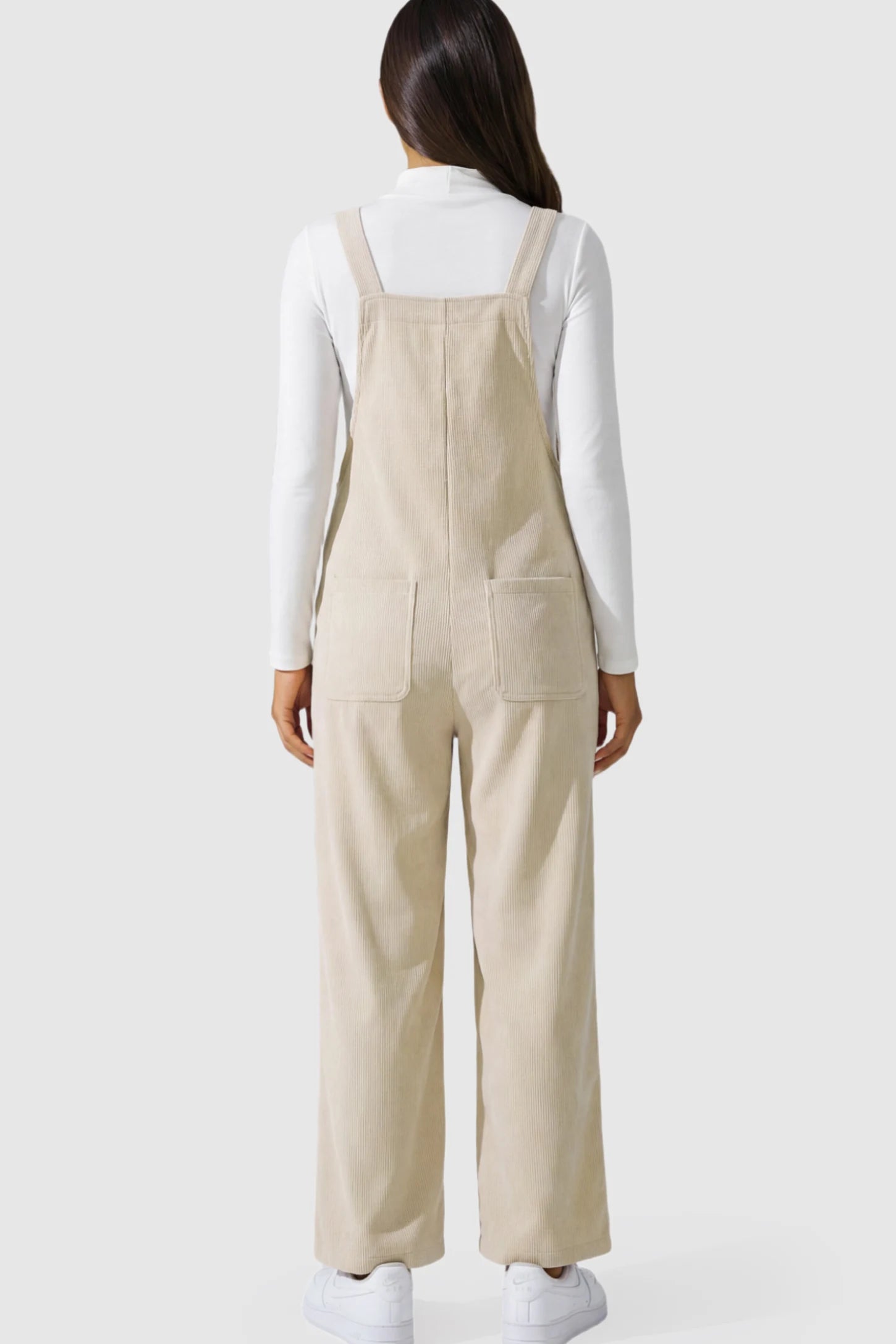 Adjustable Strap Wide-Leg Corduroy Maternity Overalls Floral Embroidered Wide-Leg Maternity Overalls in apricot on a pregnant model.