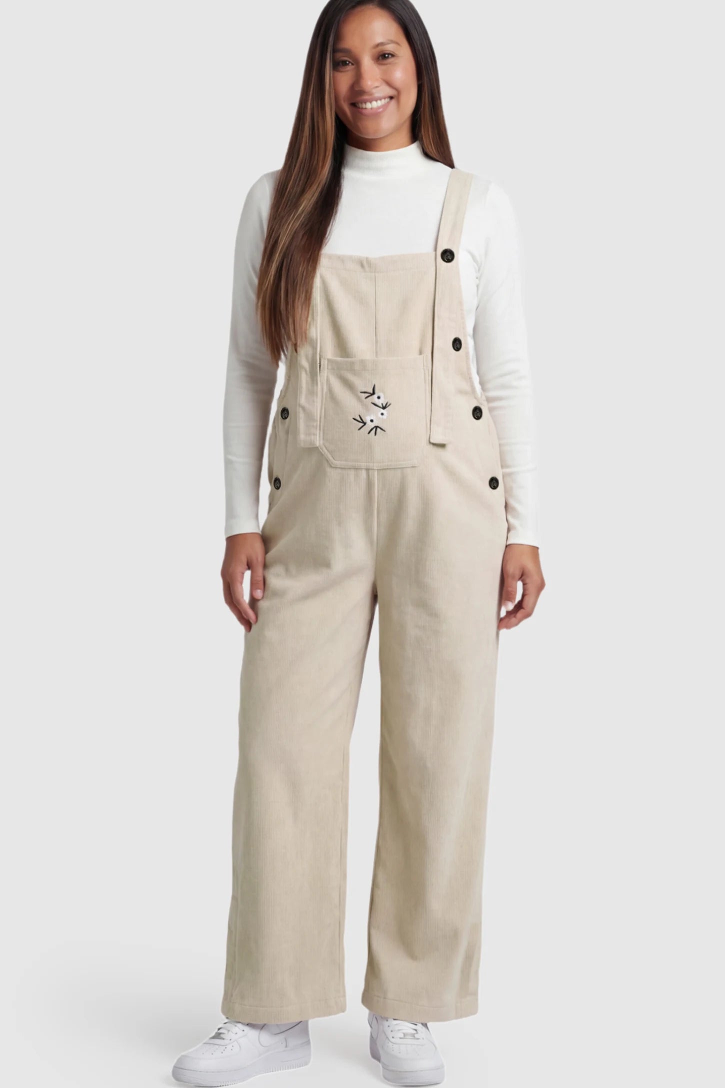 Adjustable Strap Wide-Leg Corduroy Maternity Overalls Floral Embroidered Wide-Leg Maternity Overalls in apricot with adjustable straps on a pregnant model.