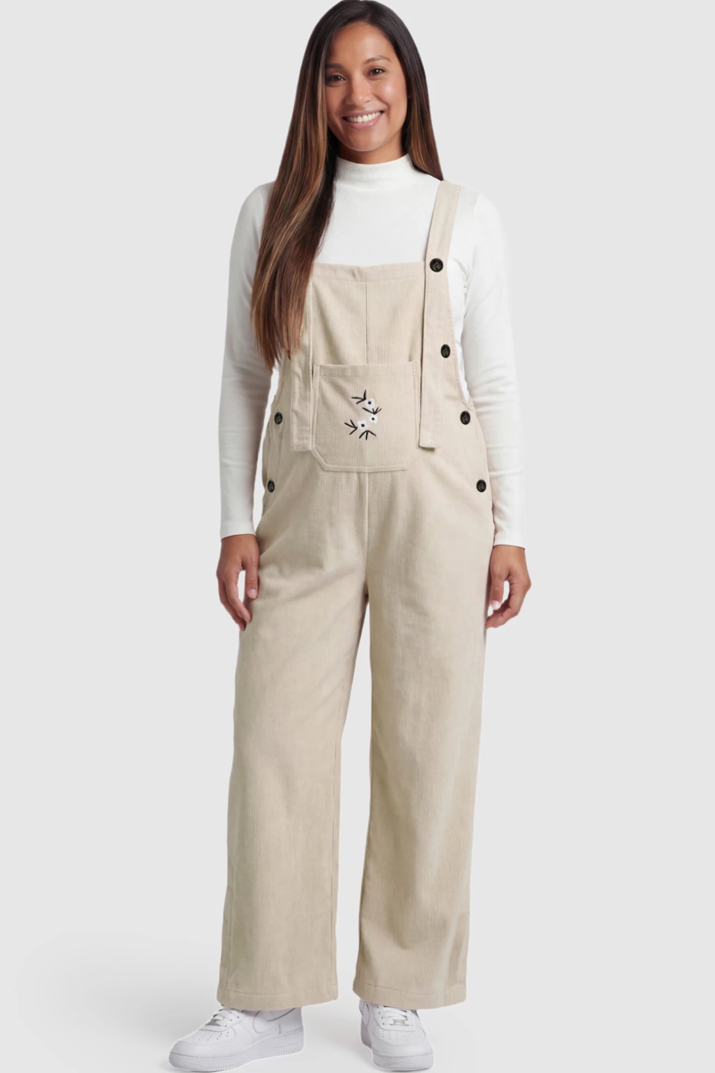 Floral Embroidered Wide-Leg Maternity Overalls in apricot with adjustable straps on a pregnant model. 