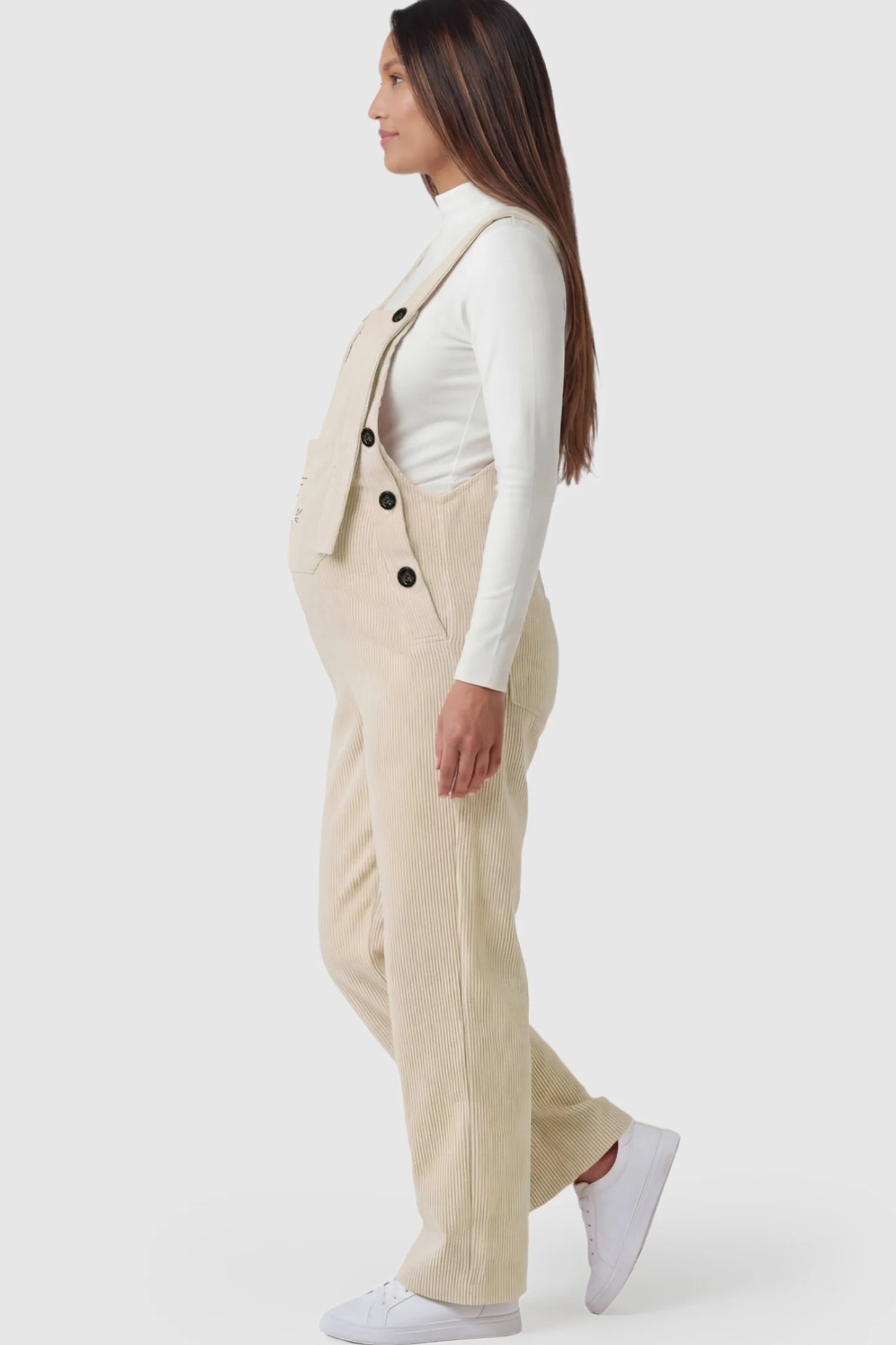 Adjustable Strap Wide-Leg Corduroy Maternity Overalls Floral Embroidered Wide-Leg Maternity Overalls in apricot with adjustable straps on a pregnant model.