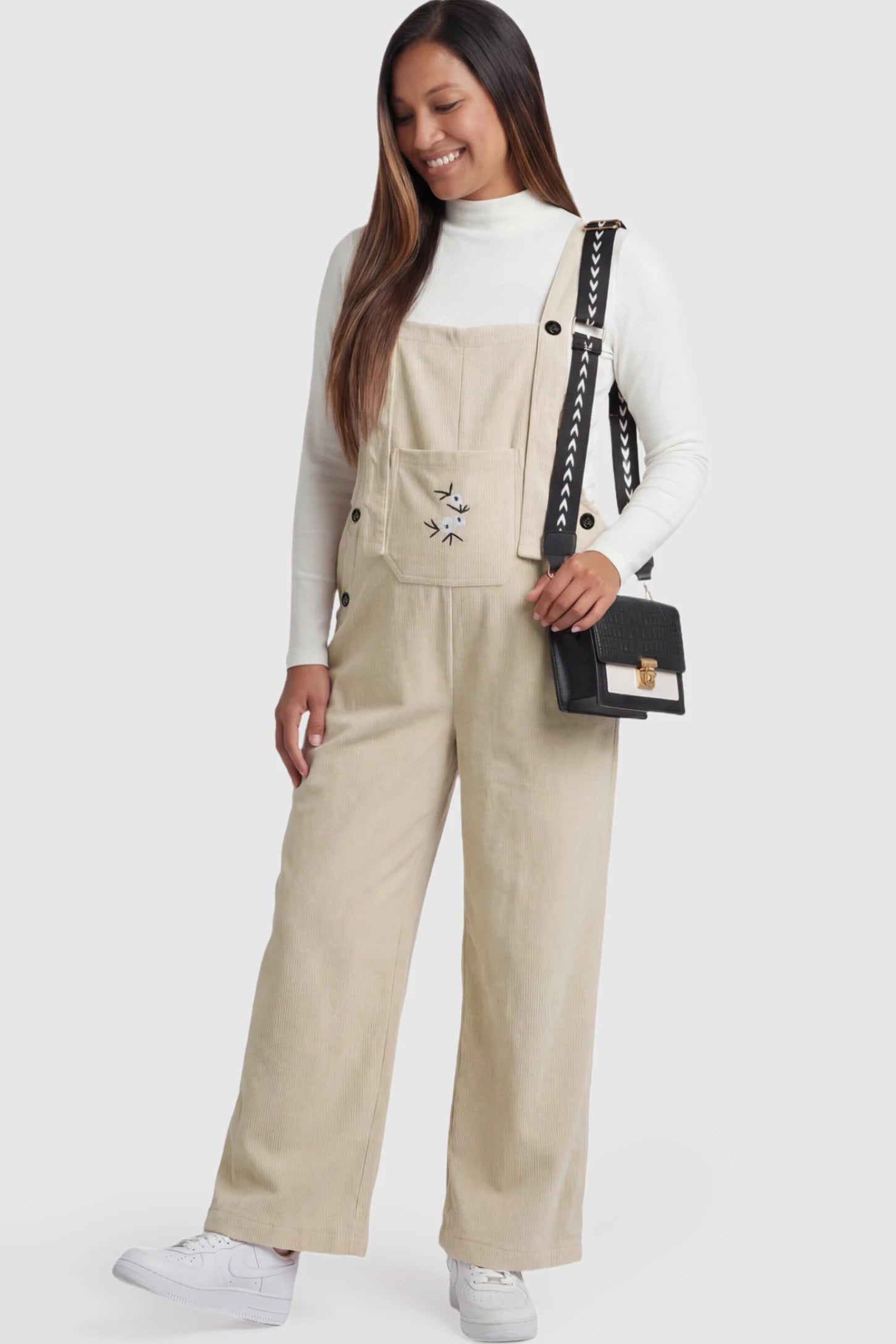 Floral Embroidered Wide-Leg Maternity Overalls in apricot with adjustable straps on a pregnant model.