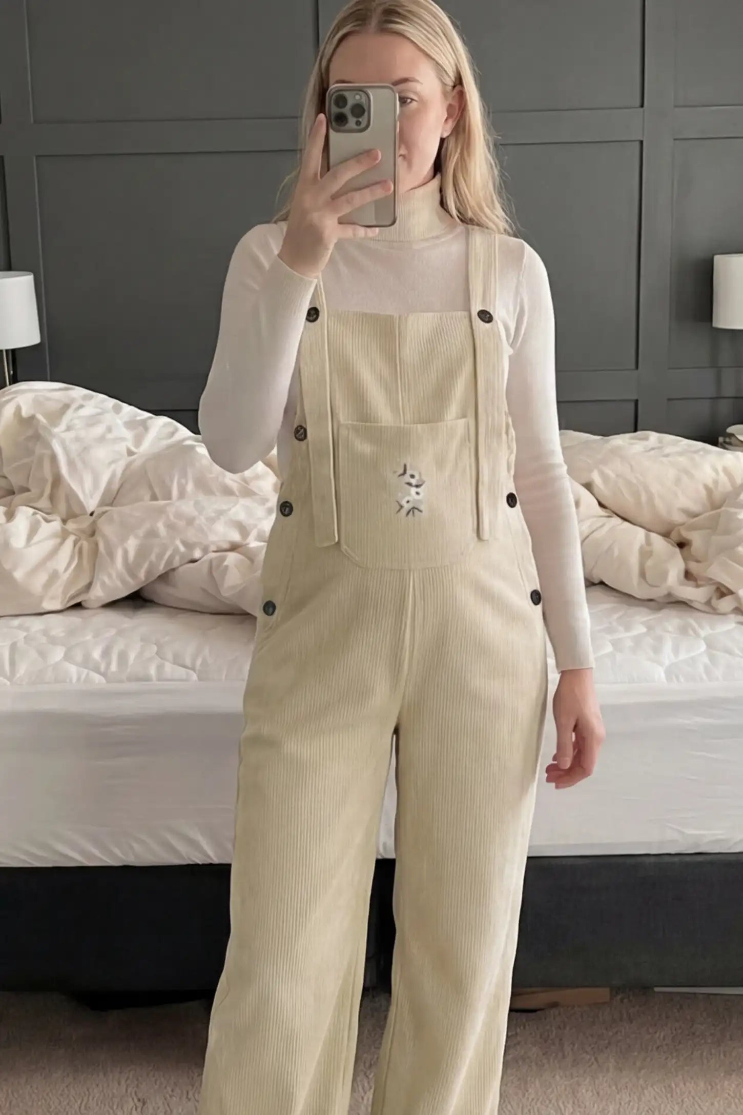 Adjustable Strap Wide-Leg Corduroy Maternity Overalls Floral Embroidered Wide-Leg Maternity Overalls in apricot with adjustable straps on a pregnant model.