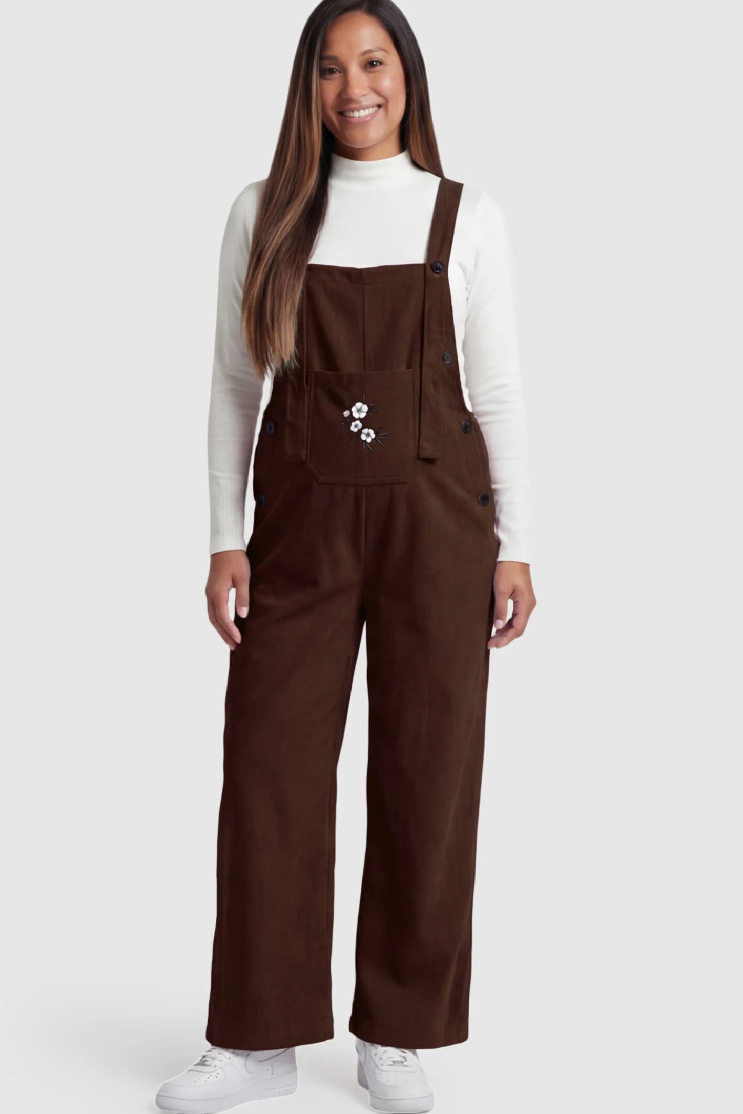 Adjustable Strap Wide-Leg Corduroy Maternity Overalls Floral Embroidered Wide-Leg Maternity Overalls in brown with adjustable straps on a pregnant model.