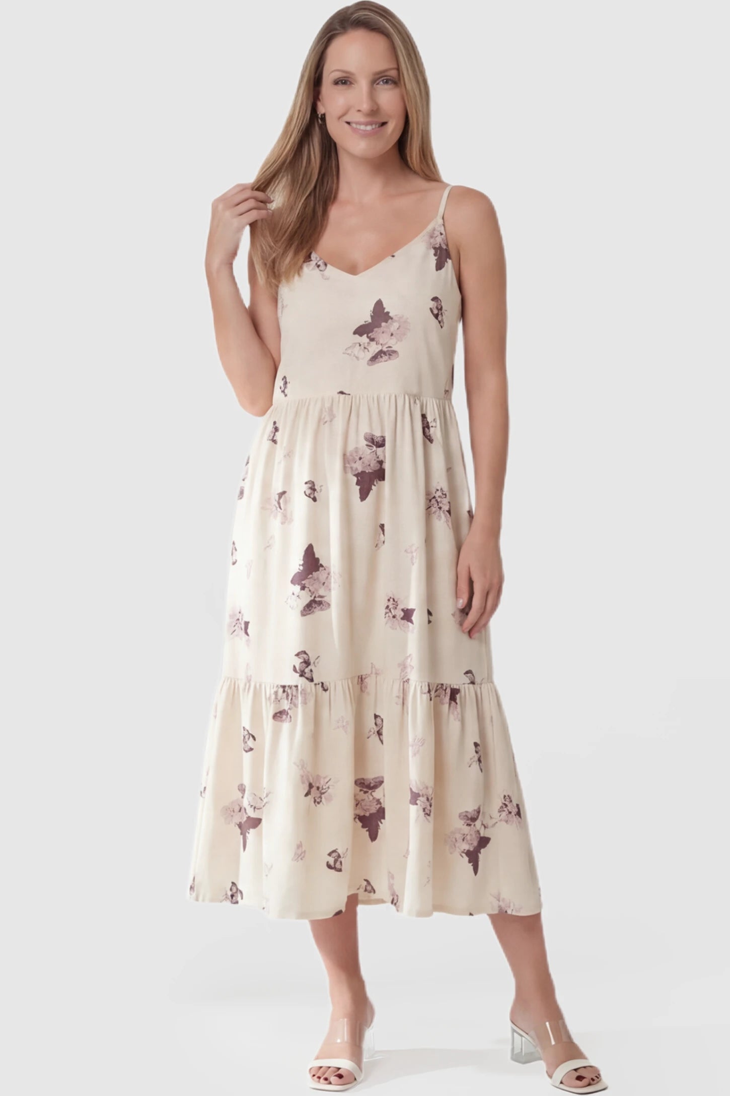 Butterfly Print Tiered Maternity Midi Dress Butterfly Print Tiered Maternity Midi Dress in Beige Brown featuring a V-neckline and spaghetti straps on a postpartum model.