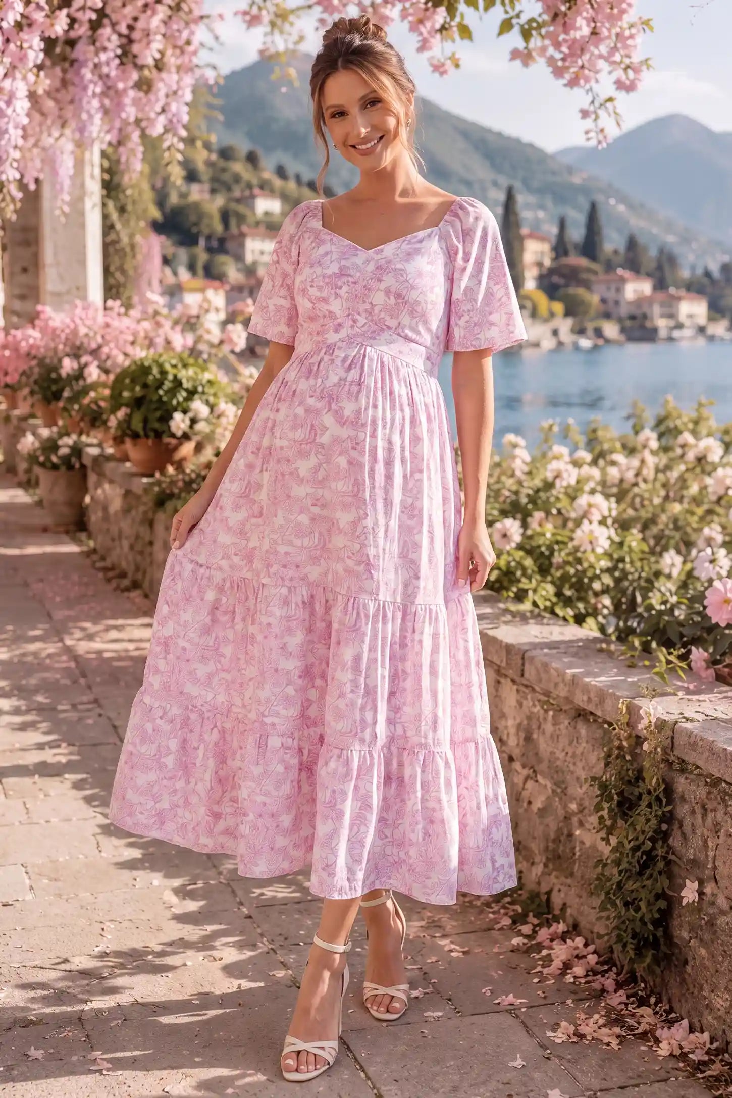 Floral V-Neck Flutter Sleeve Maternity Midi Dress Floral V-Neck Flutter Sleeve Maternity Midi Dress in Pink Floral with a smocked back and tiered skirt, lifestyle view on a pregnant model.