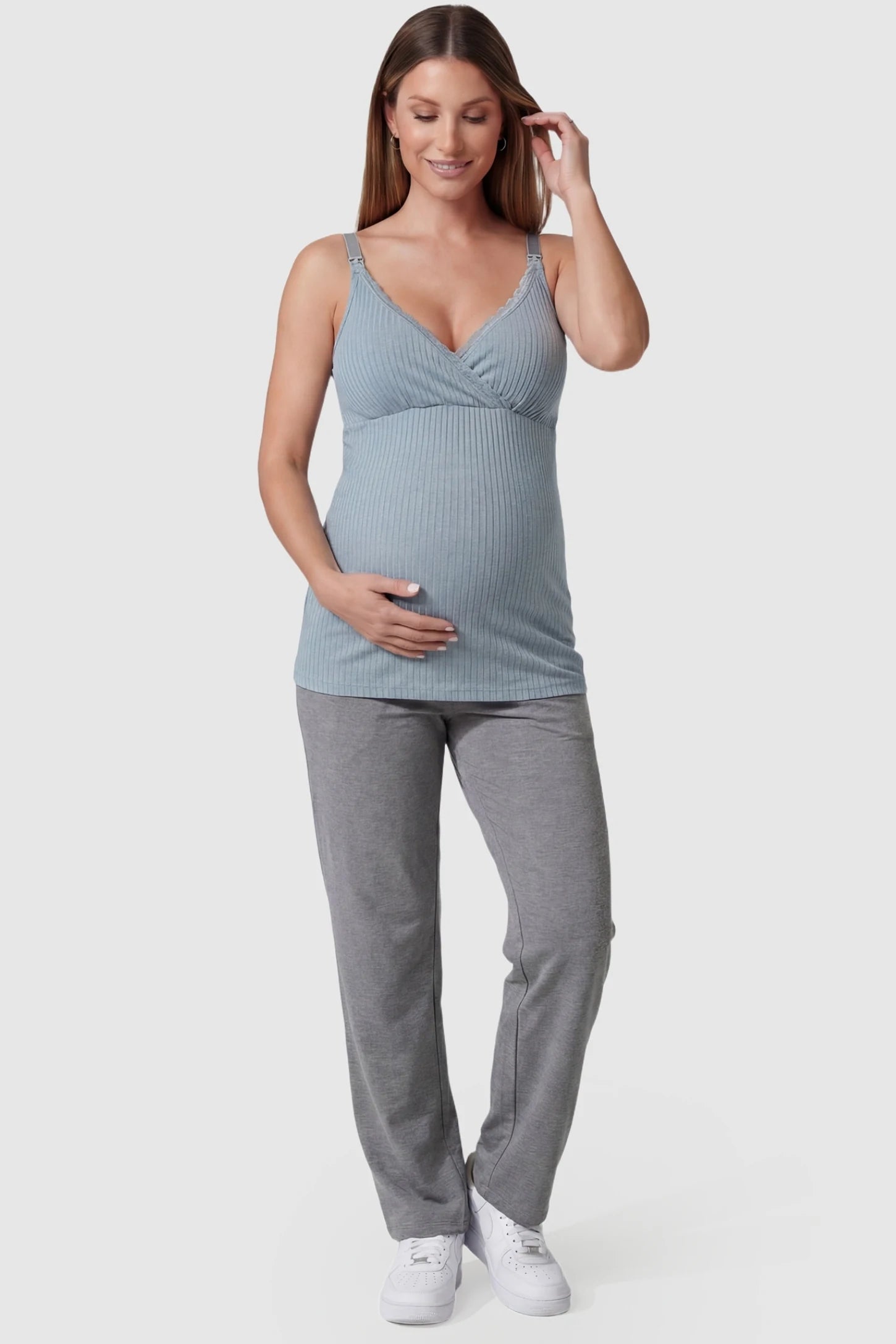 Padded Ribbed Maternity & Nursing Camisole Blue Padded Ribbed Maternity Camisole with lace-trim V-neckline on a pregnant model in a front view.