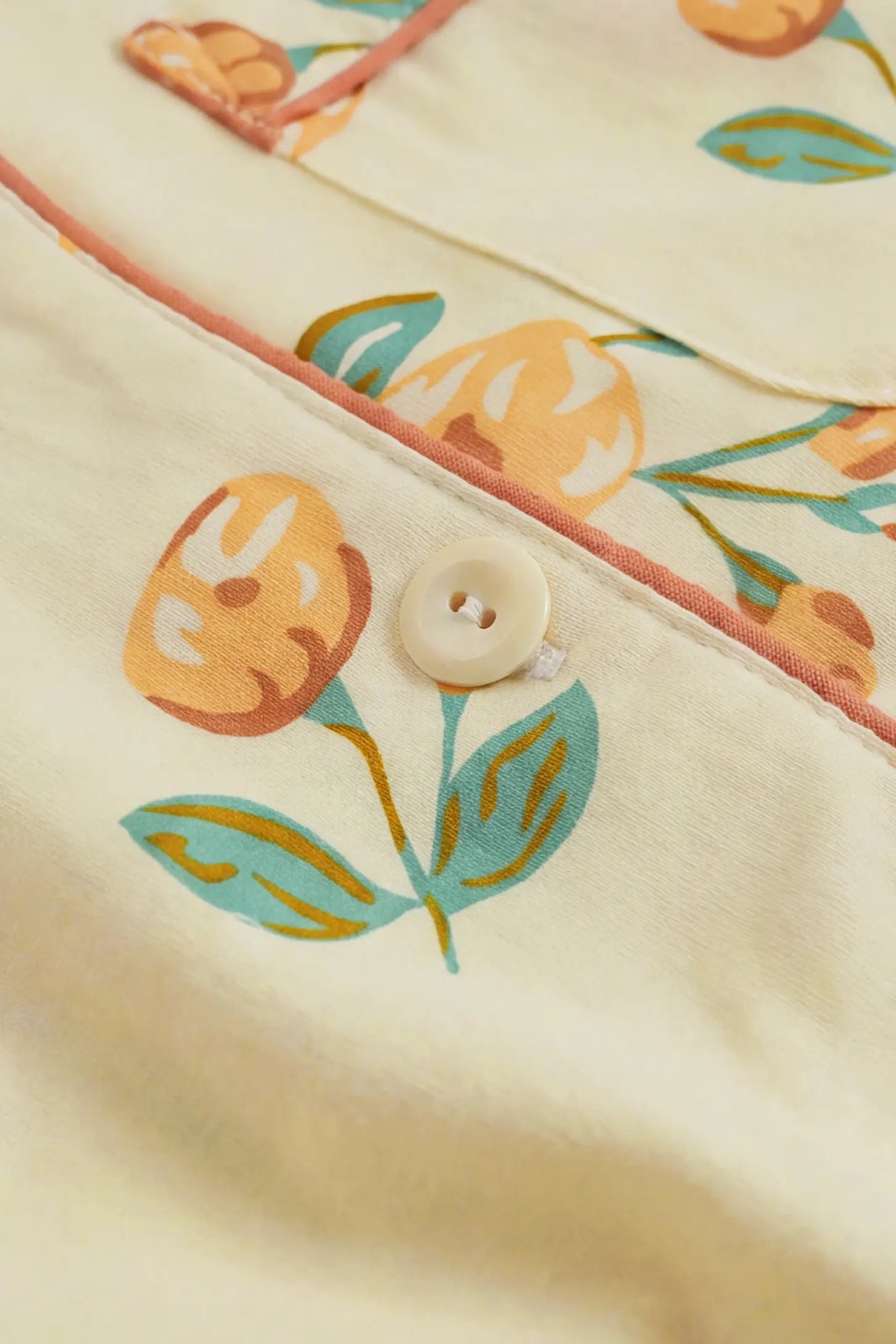 Peony Floral Organic Cotton Nursing PJ Set Peony Floral Organic Cotton Nursing PJ Set in Vintage Peony featuring delicate floral print, fine button detailing, contrast piping, and premium organic cotton texture, fabric close-up view.