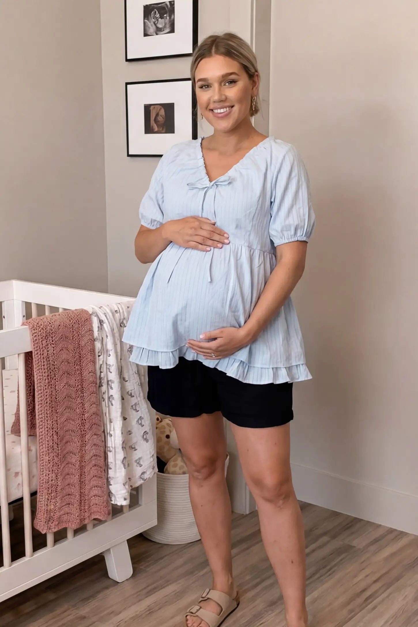 Drawstring V-Neck Peplum Maternity Top Drawstring V-neck peplum maternity top in blue with drawstring V-neck detail and puff sleeves, front view on pregnant model