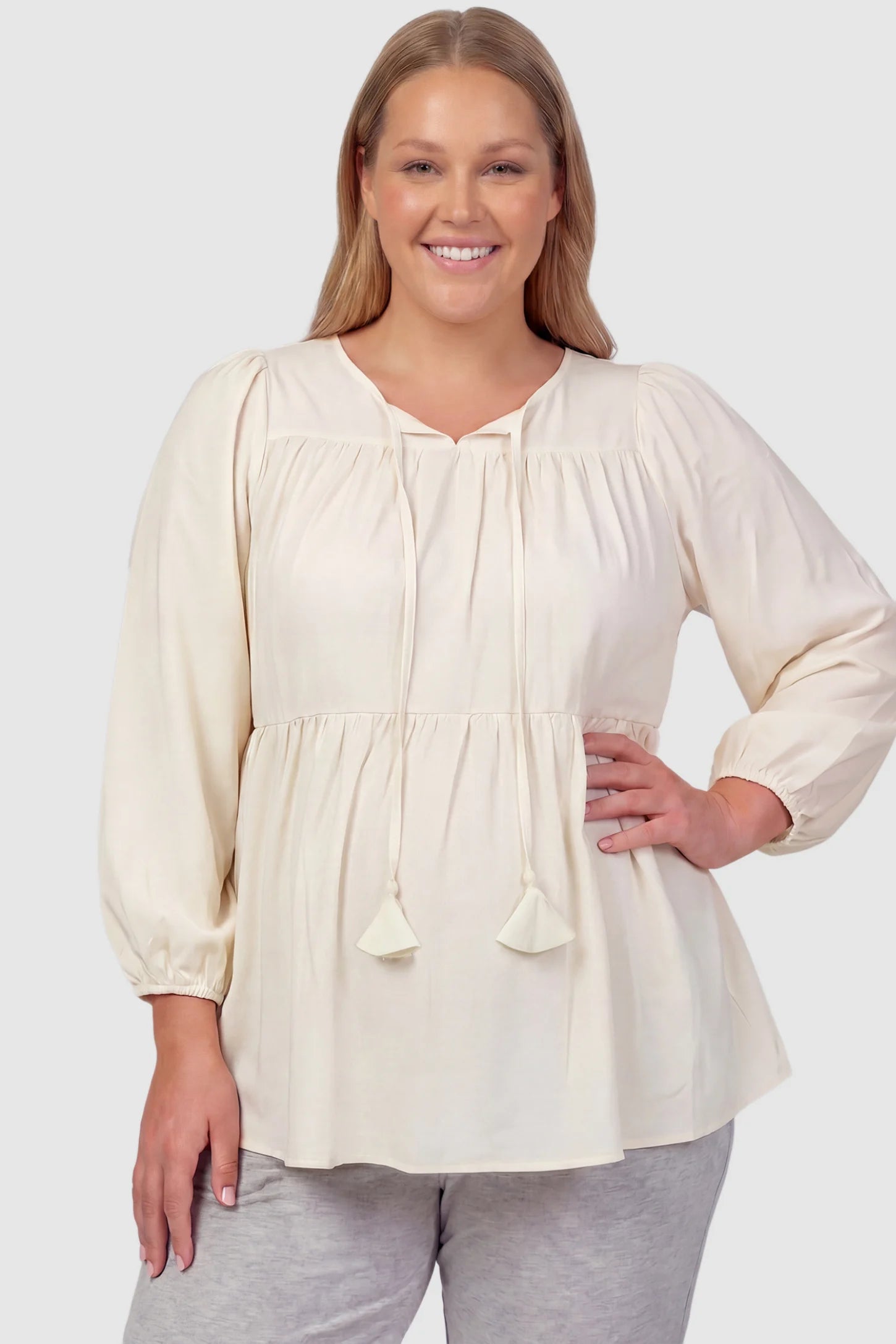 Tie-Front Tassel Long Sleeve Peplum Maternity Blouse Tie-front tassel long sleeve peplum maternity blouse in pale yellow with tie-front tassel detail, front view on plus-size model
