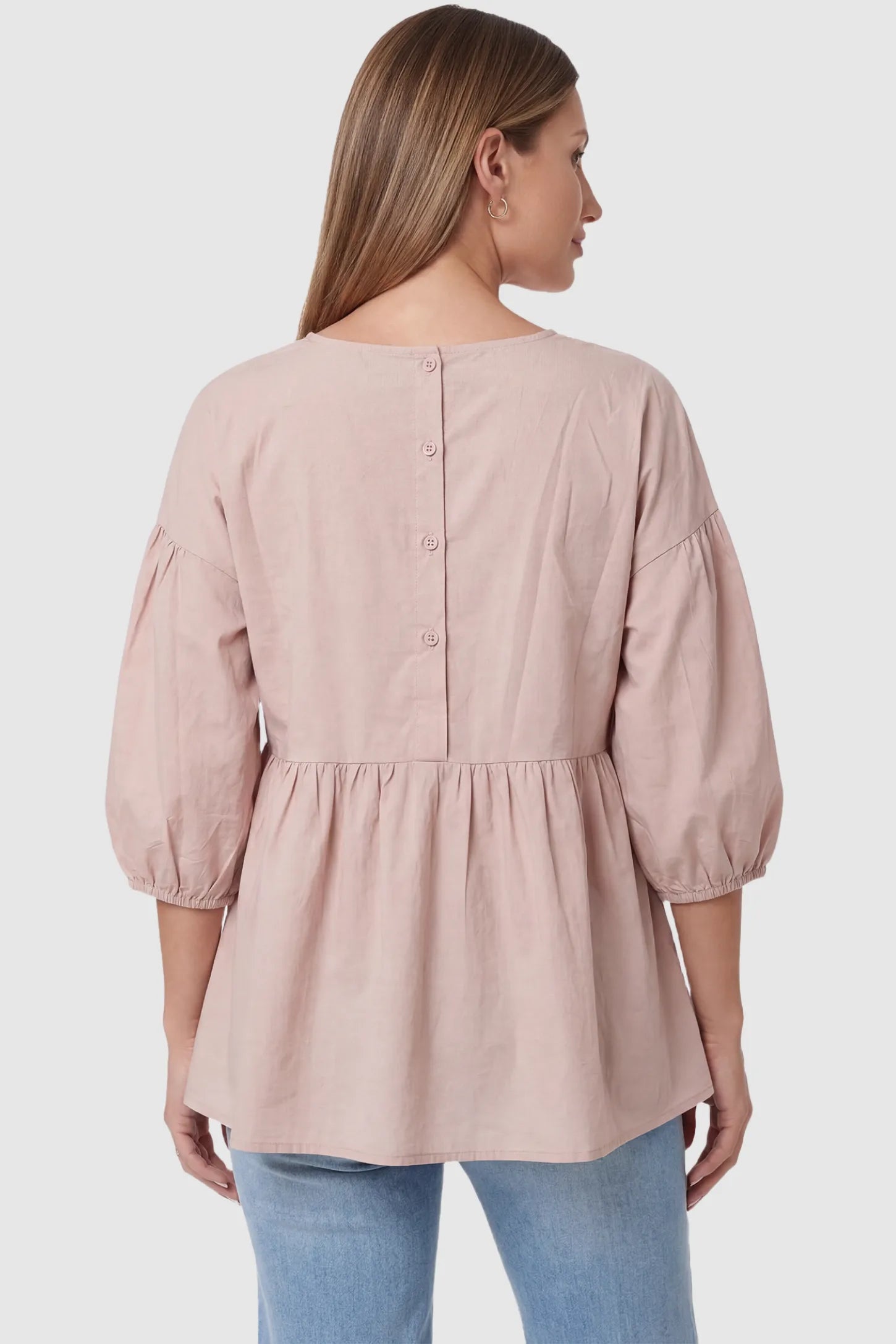 Peplum Round Neck Maternity Blouse Peplum round neck maternity blouse in pink with button-down back closure, back view on pregnant model