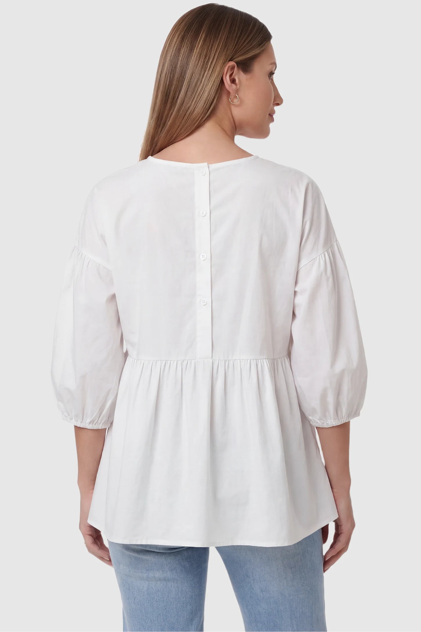 Peplum Round Neck Maternity Blouse Peplum round neck maternity blouse in white with button-down back closure, back view on pregnant model