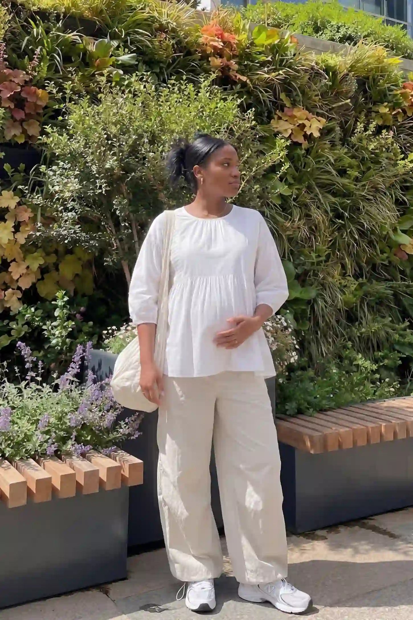 Peplum Round Neck Maternity Blouse Peplum round neck maternity blouse in white with flowy peplum and 3/4 sleeves, front view on pregnant model