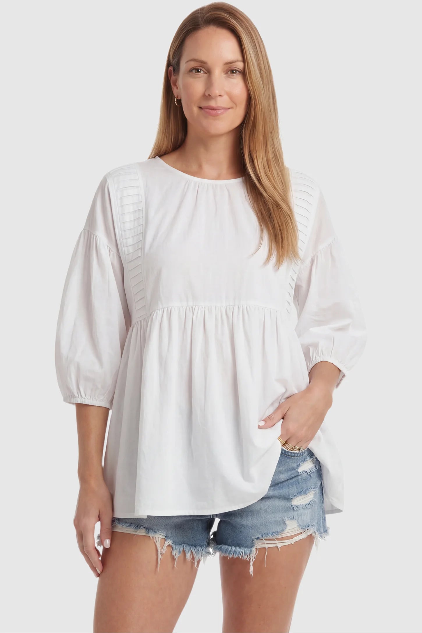 Peplum Round Neck Maternity Blouse Peplum round neck maternity blouse in white with flowy peplum and 3/4 sleeves, front view on postpartum model