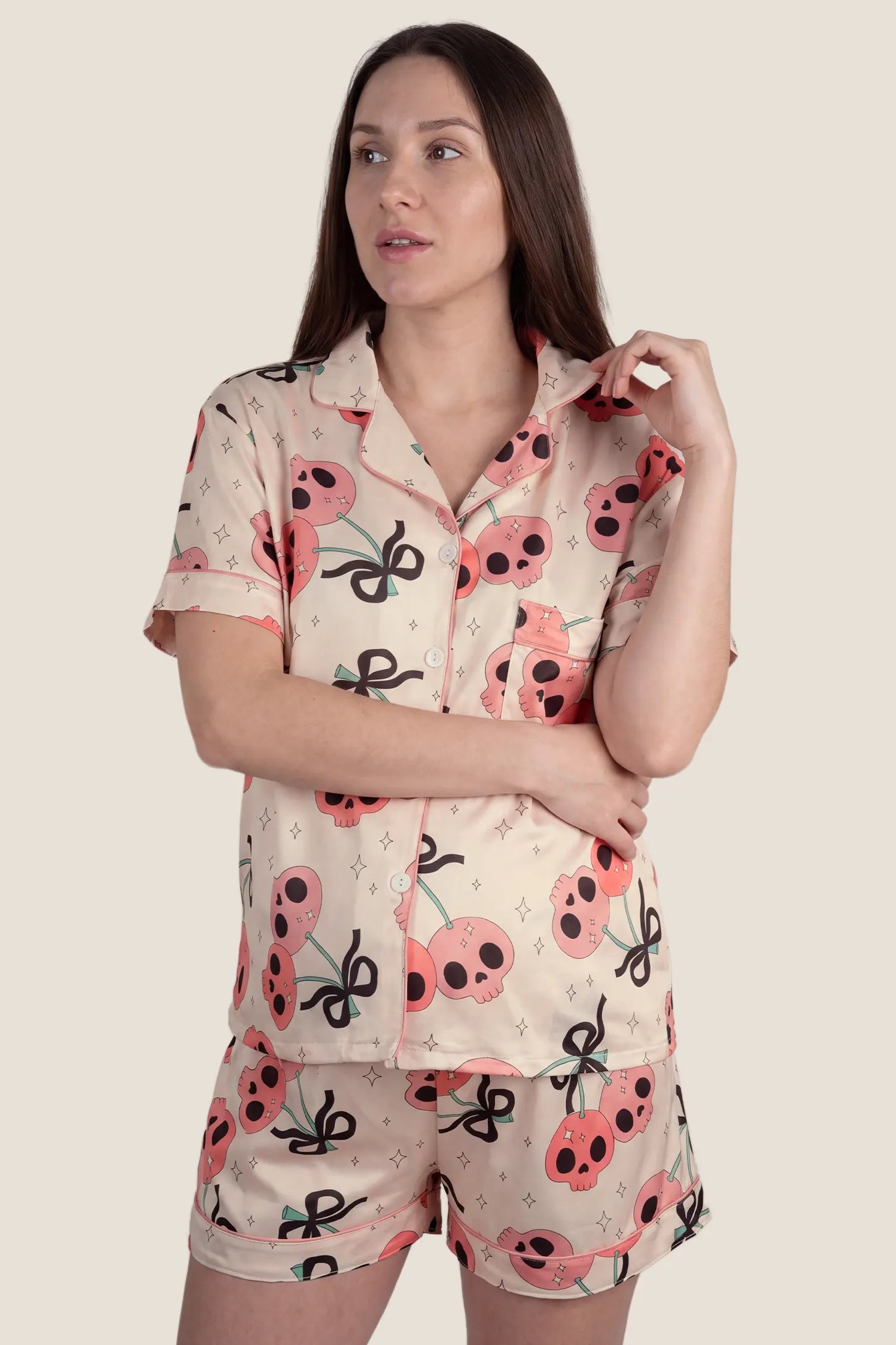 Pink Skull Cherry Button-Up Maternity Pajama Set in Pink Skull featuring a short-sleeve button-up top and comfortable lounge shorts on a pregnant model, full-body front view.