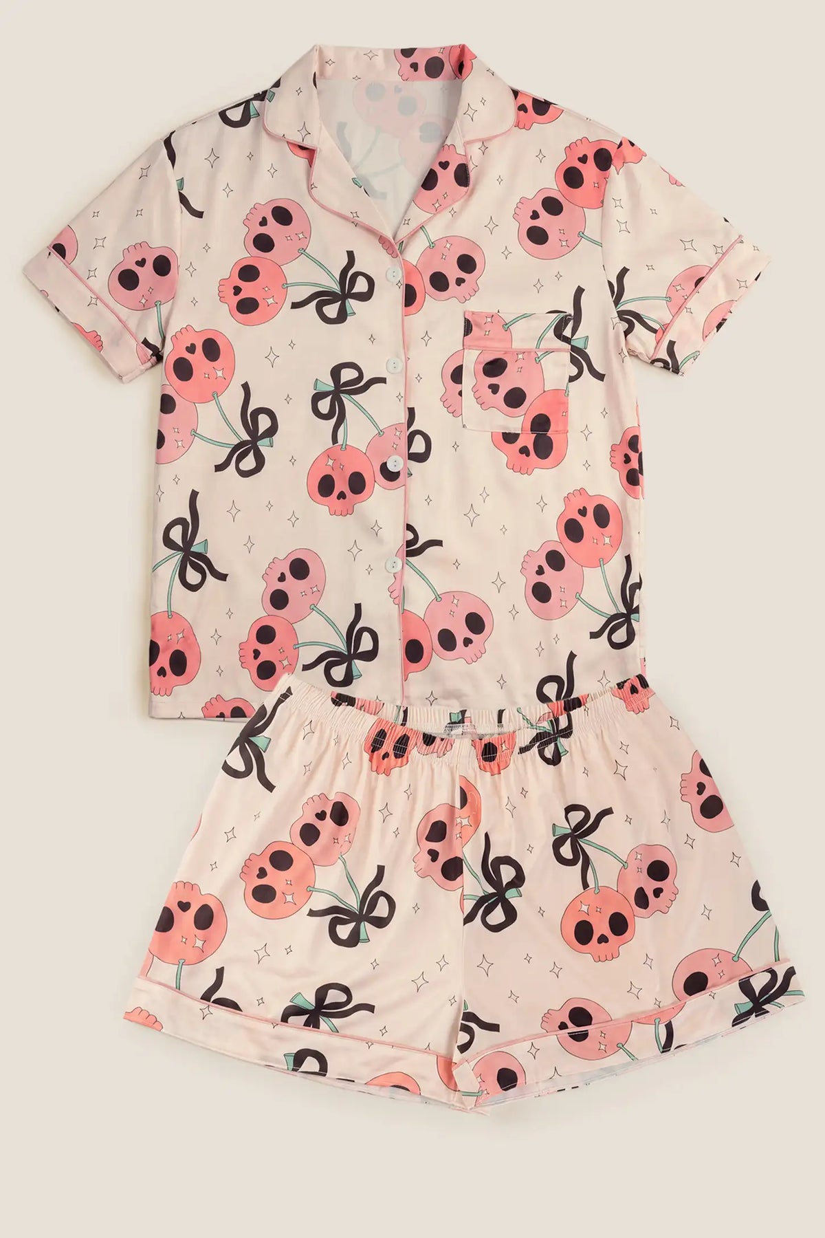 Pink Skull Cherry Button-Up Maternity Pajama Set Pink Skull Cherry Button-Up Maternity Pajama Set in Pink Skull featuring the complete two-piece Halloween maternity pajama set layout with collared button-up top and elastic shorts, flat lay product tile view.