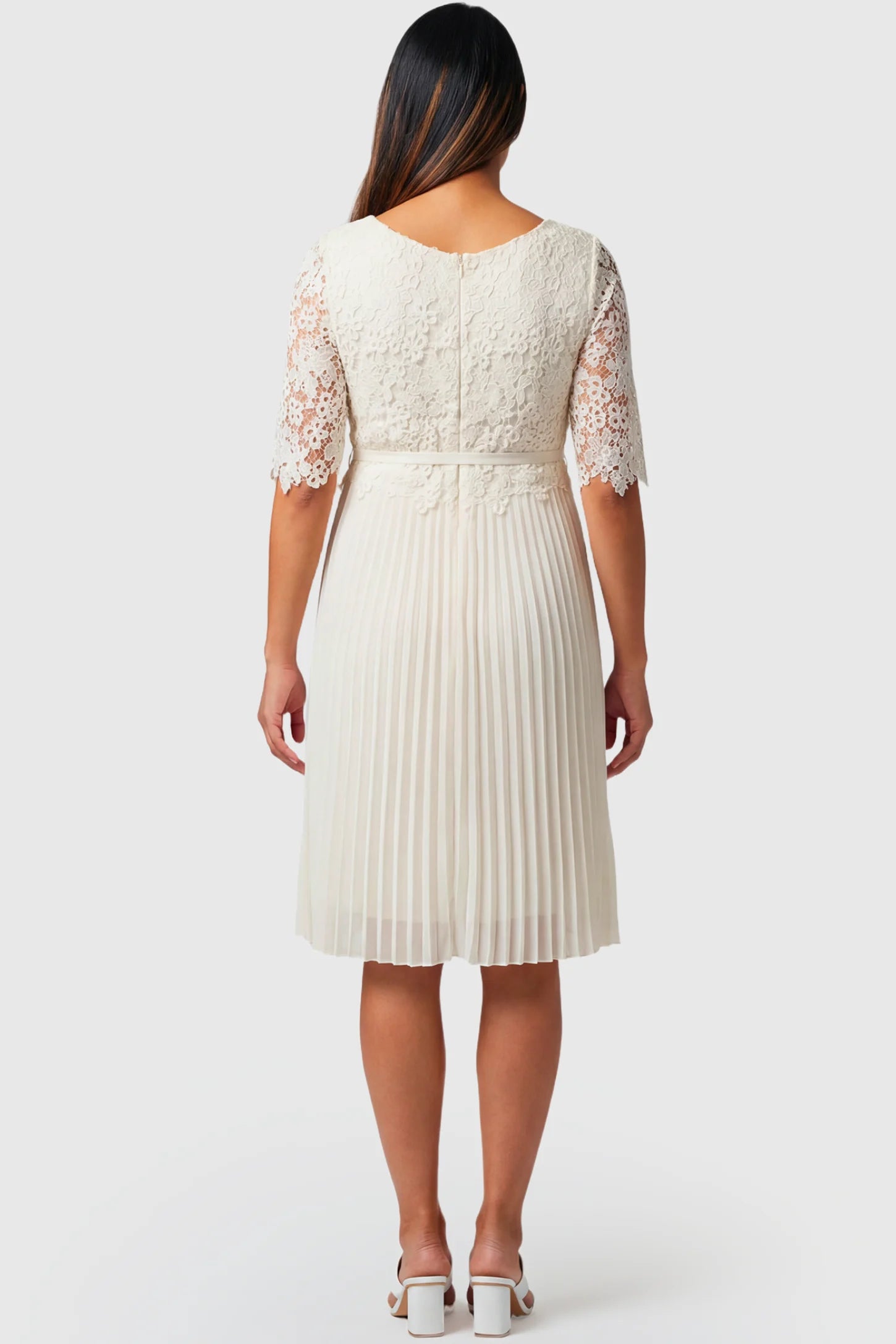 Pleated 3/4 Lace Sleeve Maternity Midi Dress Pleated 3/4 Lace Sleeve Maternity Midi Dress in white featuring lace sleeves, empire waist, and flowy pleated skirt on pregnant model.