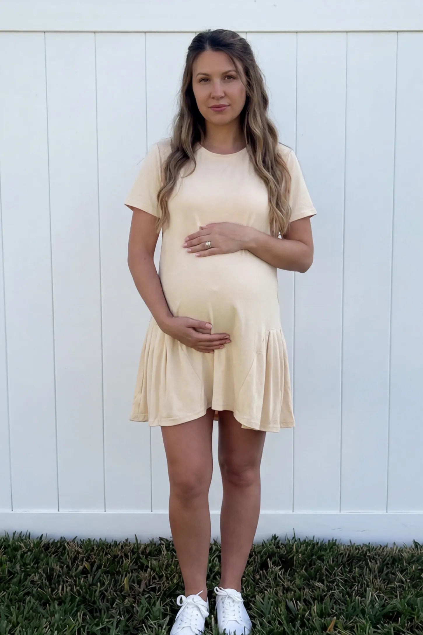 Pleated Hem A-line Maternity Short Dress Pleated hem A-line maternity short dress in beige with classic round neckline, front view on pregnant model