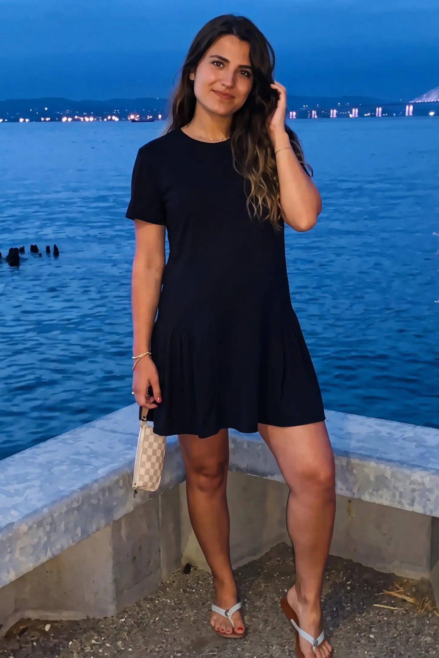 Pleated Hem A-line Maternity Short Dress Pleated hem A-line maternity short dress in black with classic round neckline, front view on pregnant model