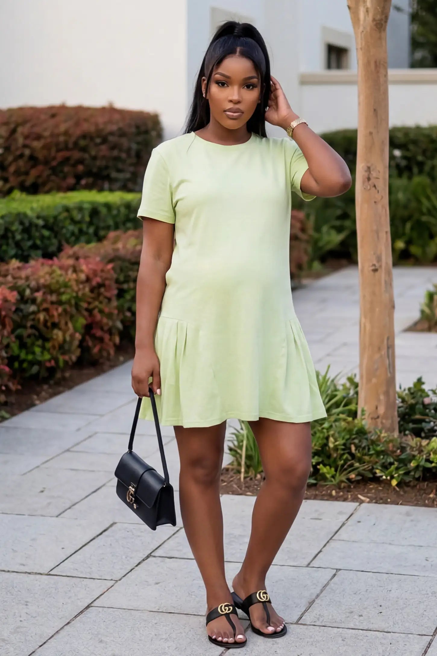 Pleated Hem A-line Maternity Short Dress Pleated hem A-line maternity short dress in green with classic round neckline, front view on pregnant model