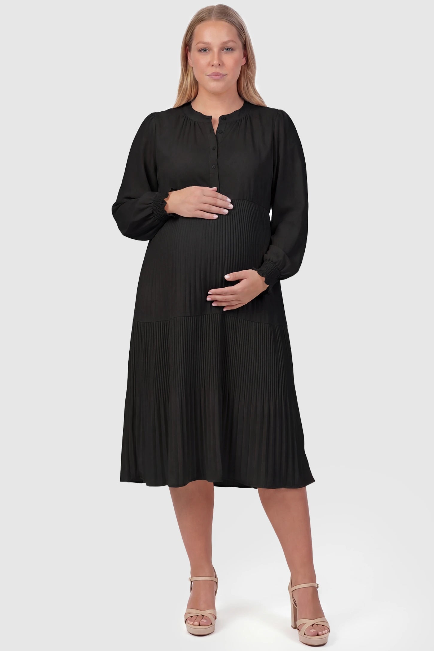 Button-Up Neck Pleated Tiered Maternity Midi Dress Button-up neck pleated tiered maternity midi dress in black with soft pleated design, front view on plus-size model