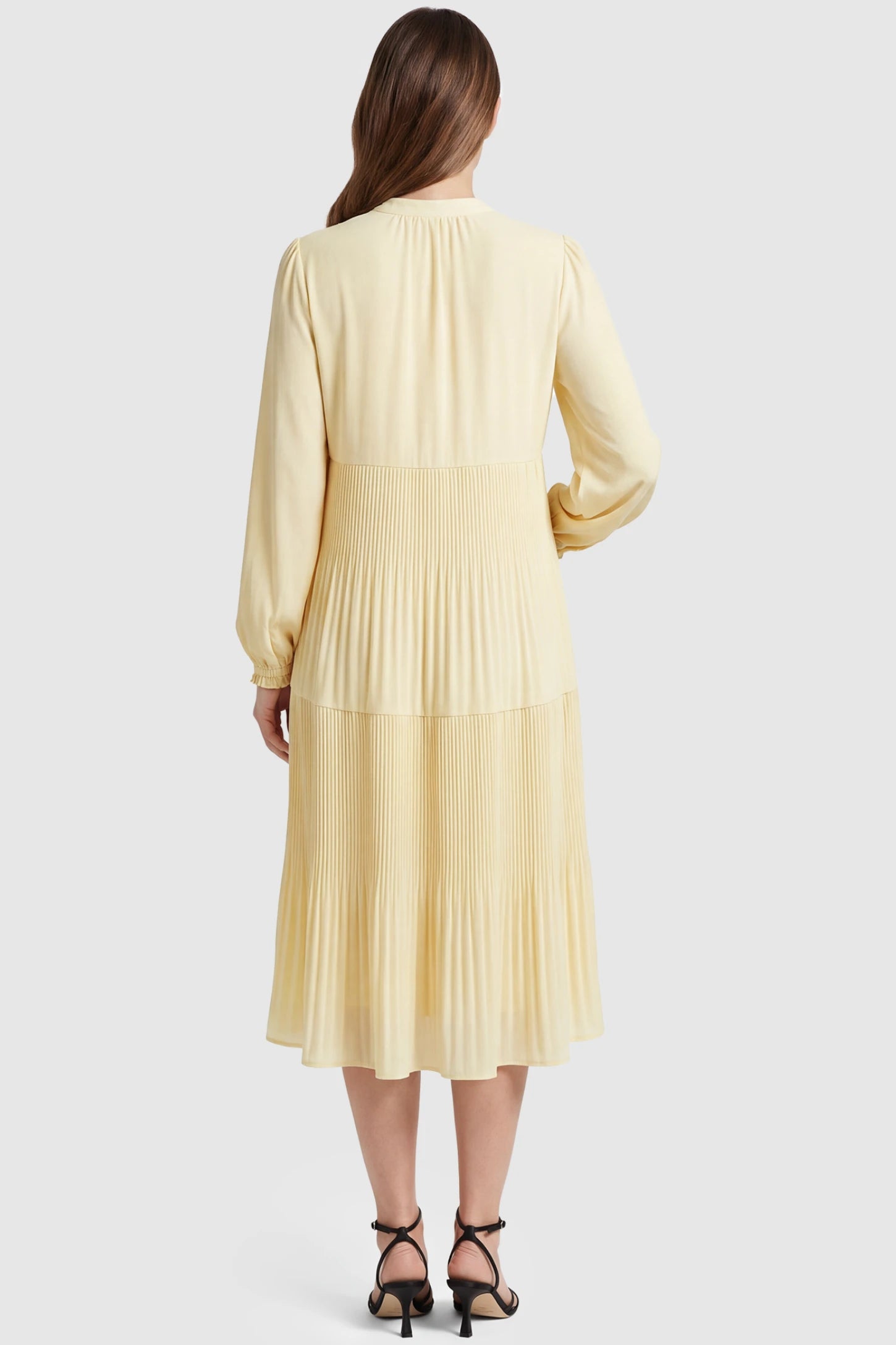 Button-Up Neck Pleated Tiered Maternity Midi Dress Button-up neck pleated tiered maternity midi dress in pale yellow with soft pleated design, back view on pregnant model