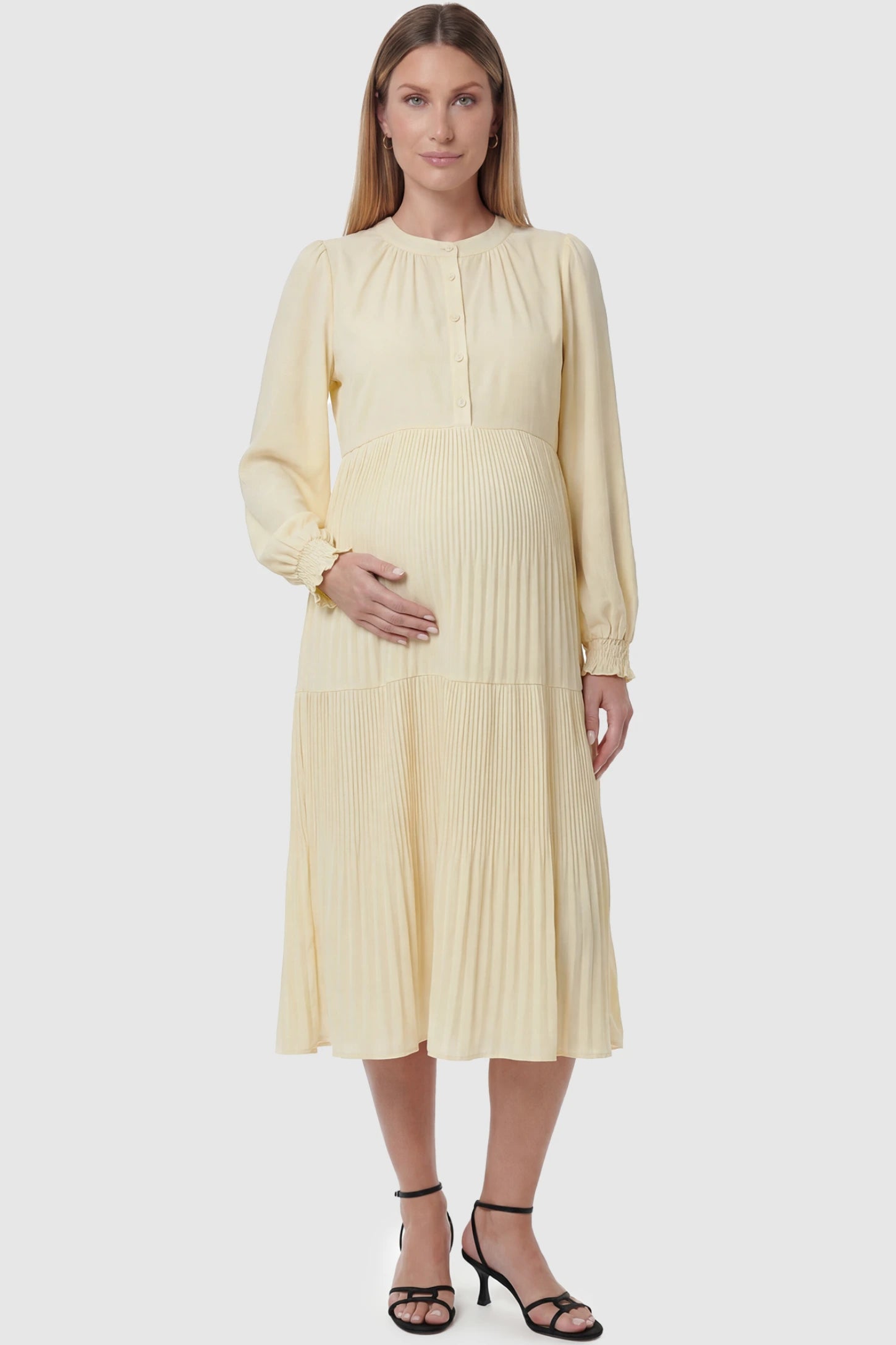 Button-Up Neck Pleated Tiered Maternity Midi Dress Button-up neck pleated tiered maternity midi dress in pale yellow with button-up neckline detail, front view on pregnant model
