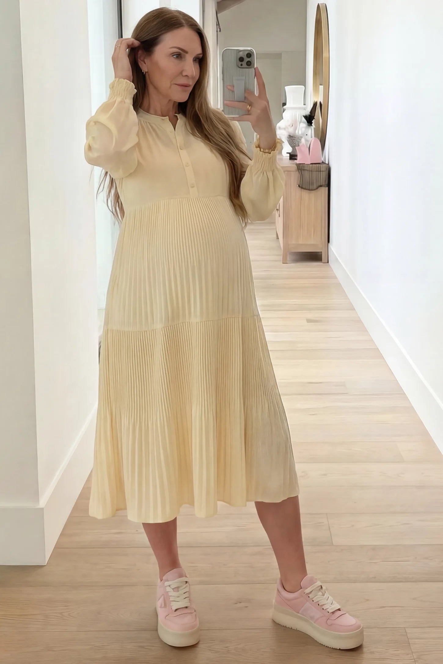 Button-Up Neck Pleated Tiered Maternity Midi Dress Button-up neck pleated tiered maternity midi dress in pale yellow with soft pleated design, front view on pregnant model