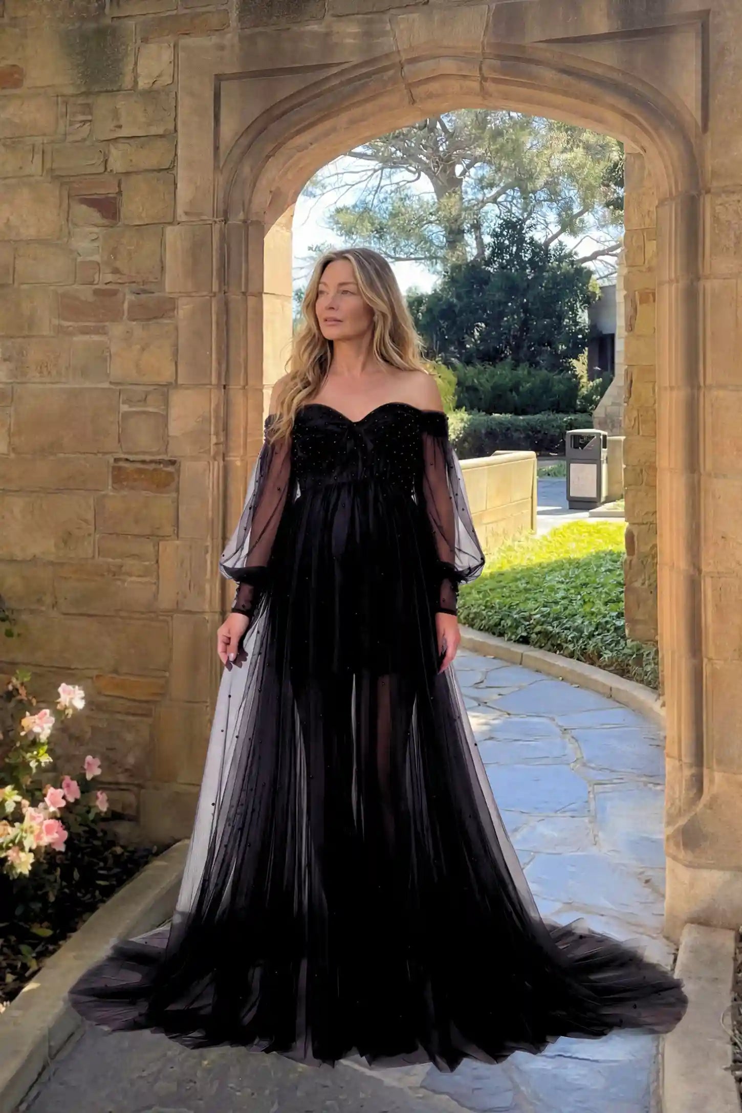 Off-Shoulder Empire Waist Maternity Gown Off-Shoulder Empire Waist Maternity Gown in black featuring a sweetheart neckline and flowy A-line silhouette on a pregnant model.