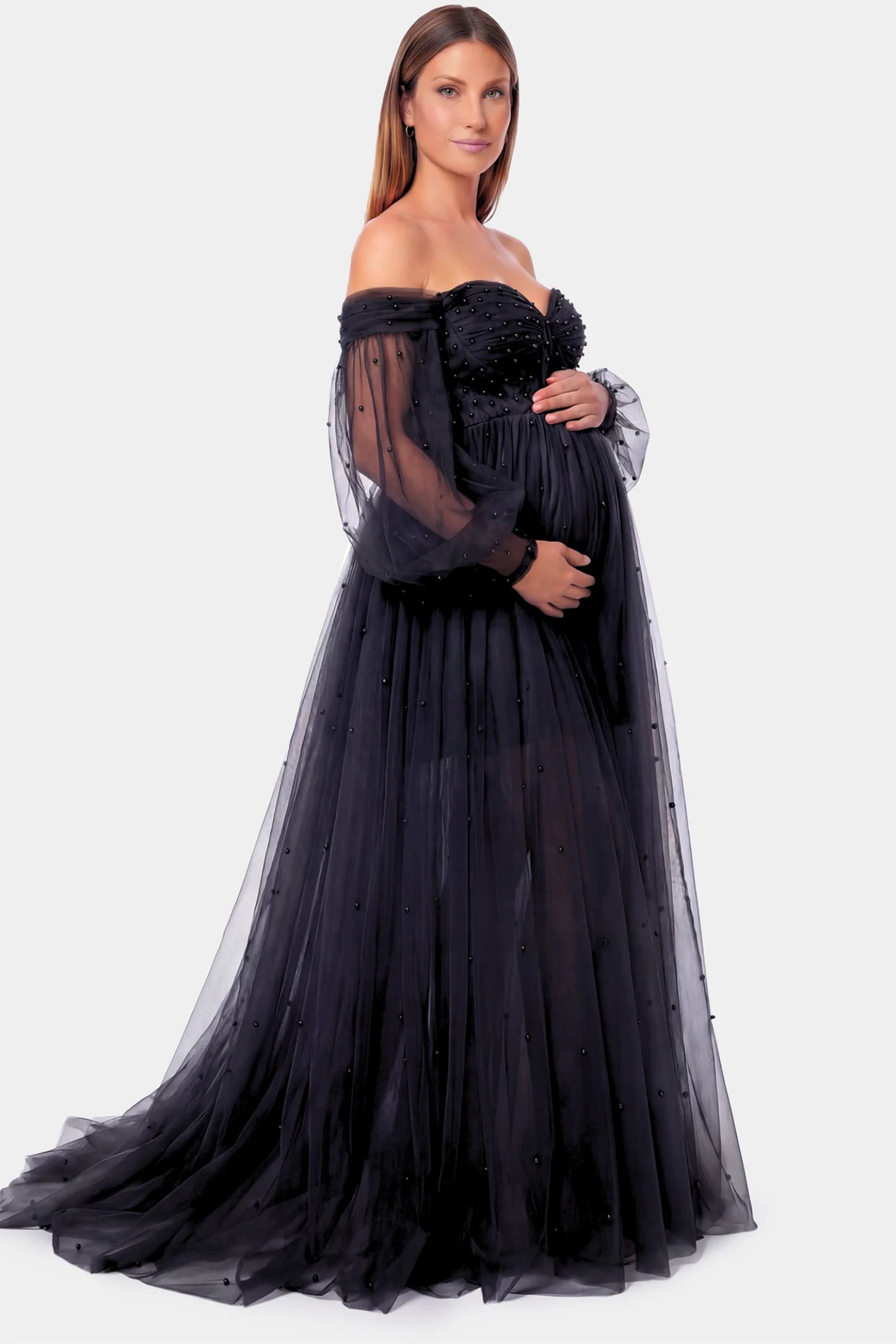 Off-Shoulder Empire Waist Maternity Gown Off-Shoulder Empire Waist Maternity Gown in black featuring a sweetheart neckline and flowy A-line silhouette on a pregnant model.