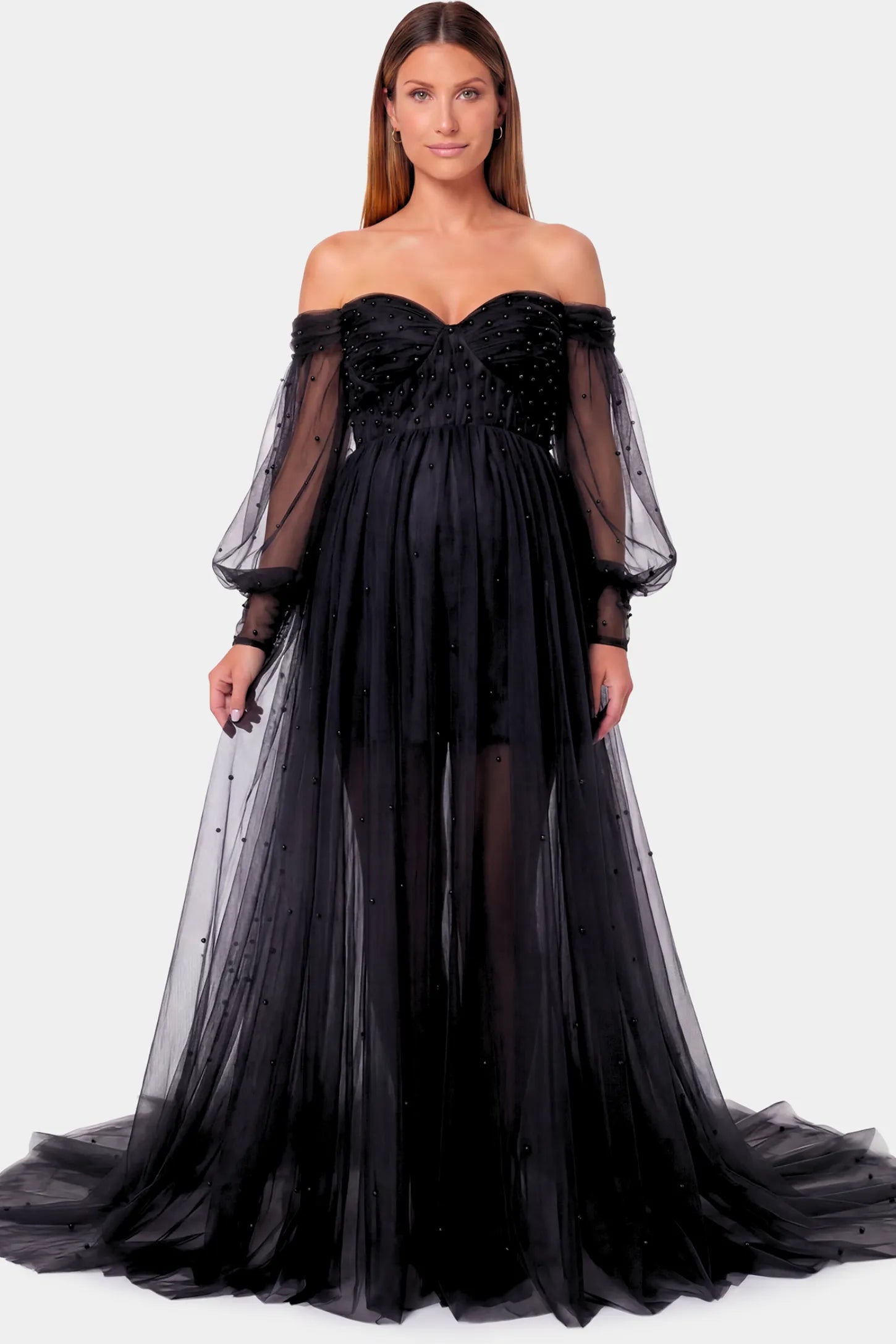 Off-Shoulder Empire Waist Maternity Gown Off-Shoulder Empire Waist Maternity Gown in black featuring a sweetheart neckline and flowy A-line silhouette on a pregnant model.