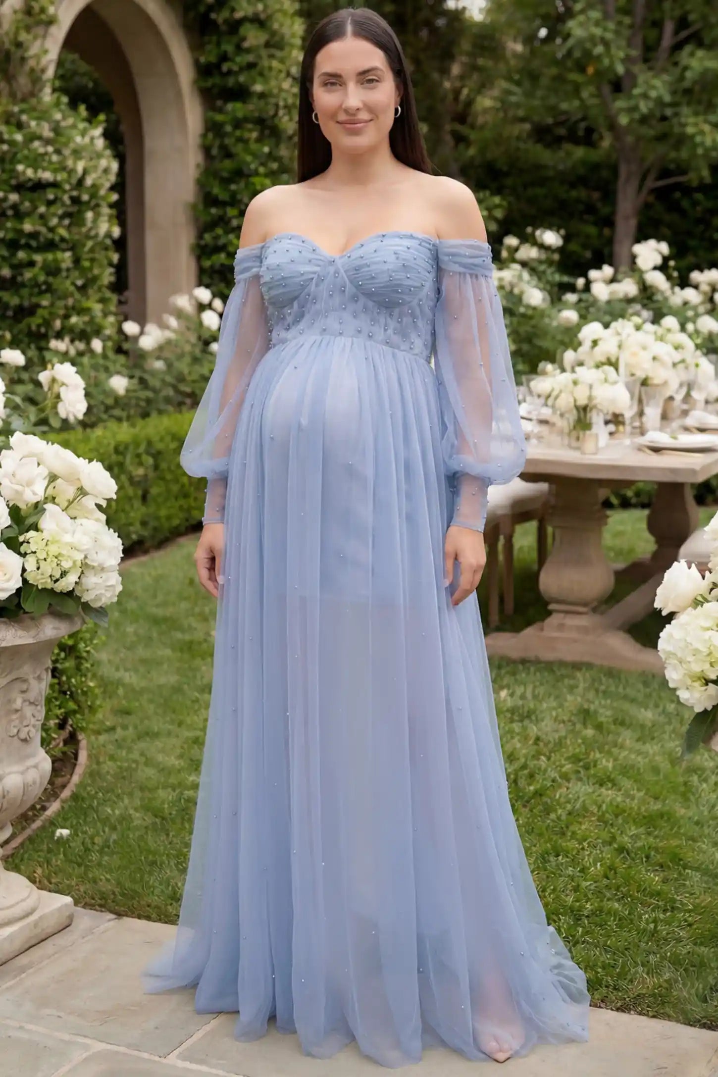 Off-Shoulder Empire Waist Maternity Gown Off-Shoulder Empire Waist Maternity Gown in blue featuring a sweetheart neckline and flowy A-line silhouette on a plus size pregnant model, front view.