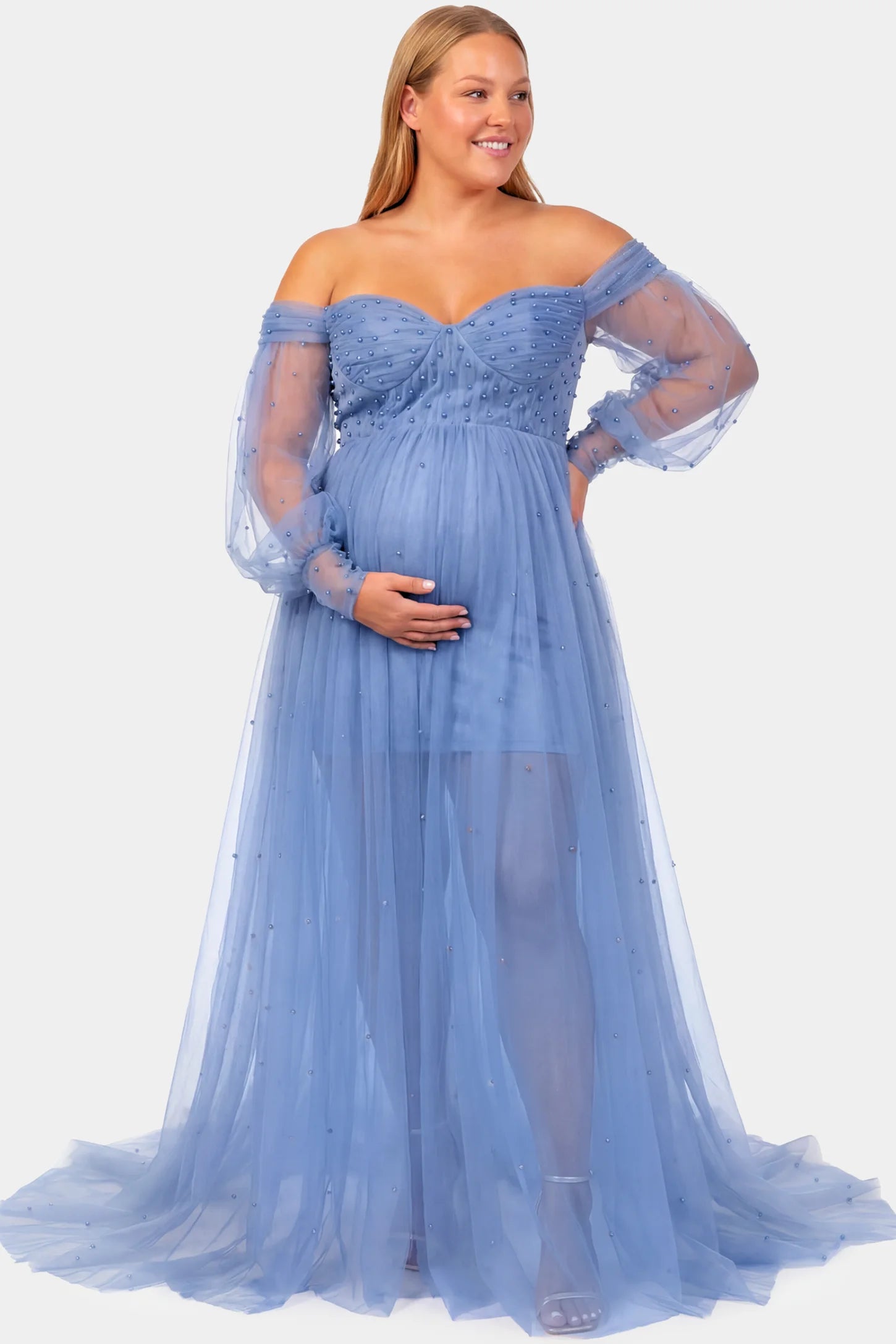 Off-Shoulder Empire Waist Maternity Gown Off-Shoulder Empire Waist Maternity Gown in blue featuring a sweetheart neckline and flowy A-line silhouette on a pregnant model.