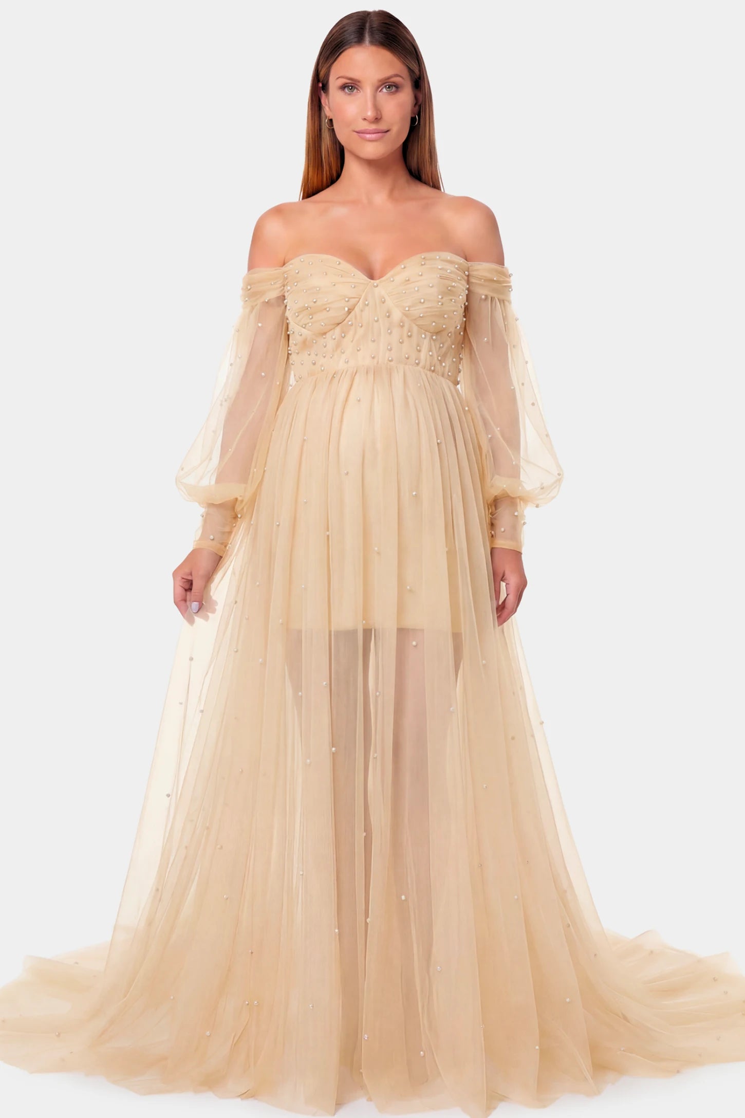 Off-Shoulder Empire Waist Maternity Gown Off-Shoulder Empire Waist Maternity Gown in camel featuring a sweetheart neckline and flowy A-line silhouette on a pregnant model.