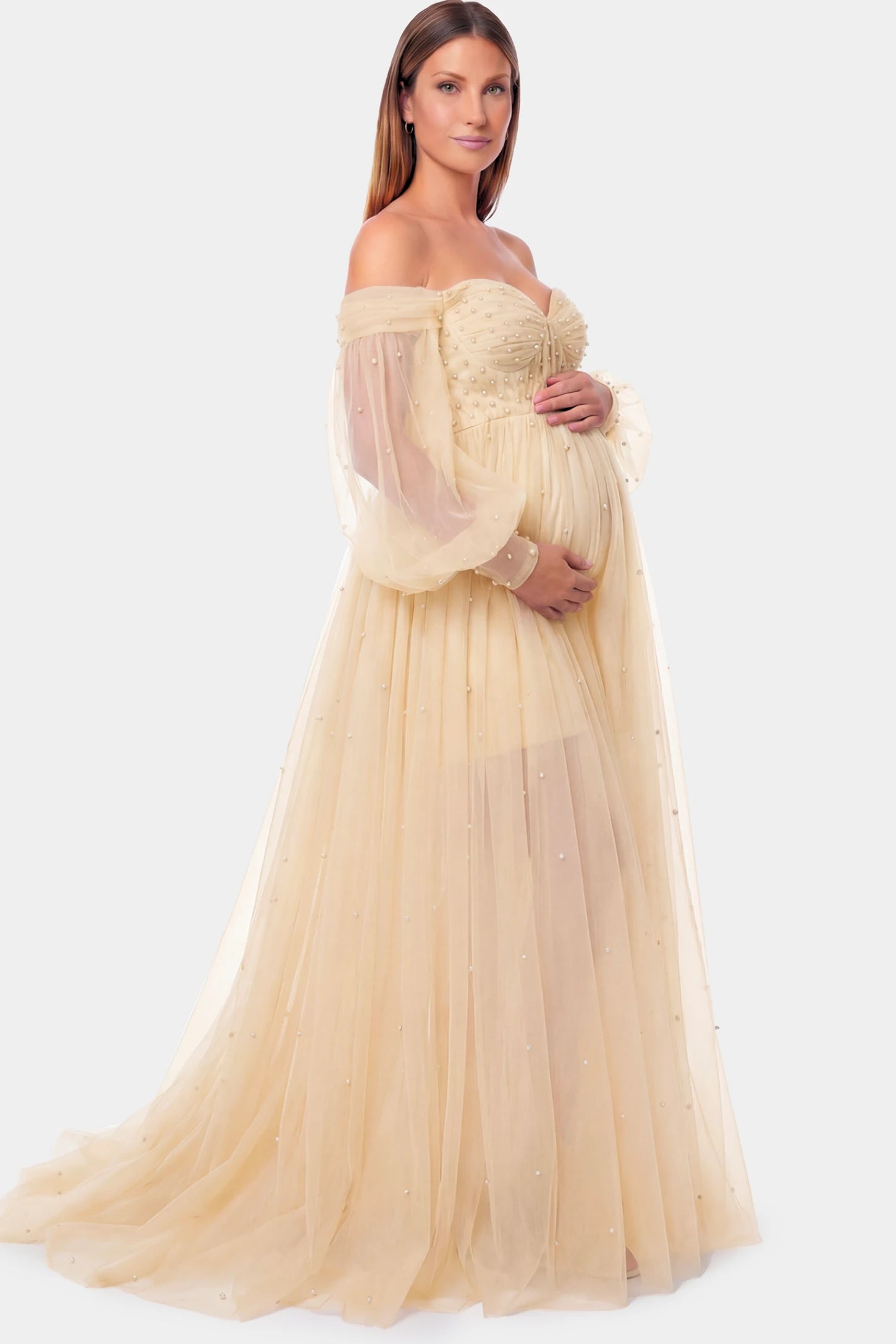 Off-Shoulder Empire Waist Maternity Gown Off-Shoulder Empire Waist Maternity Gown in camel featuring a sweetheart neckline and flowy A-line silhouette on a pregnant model.