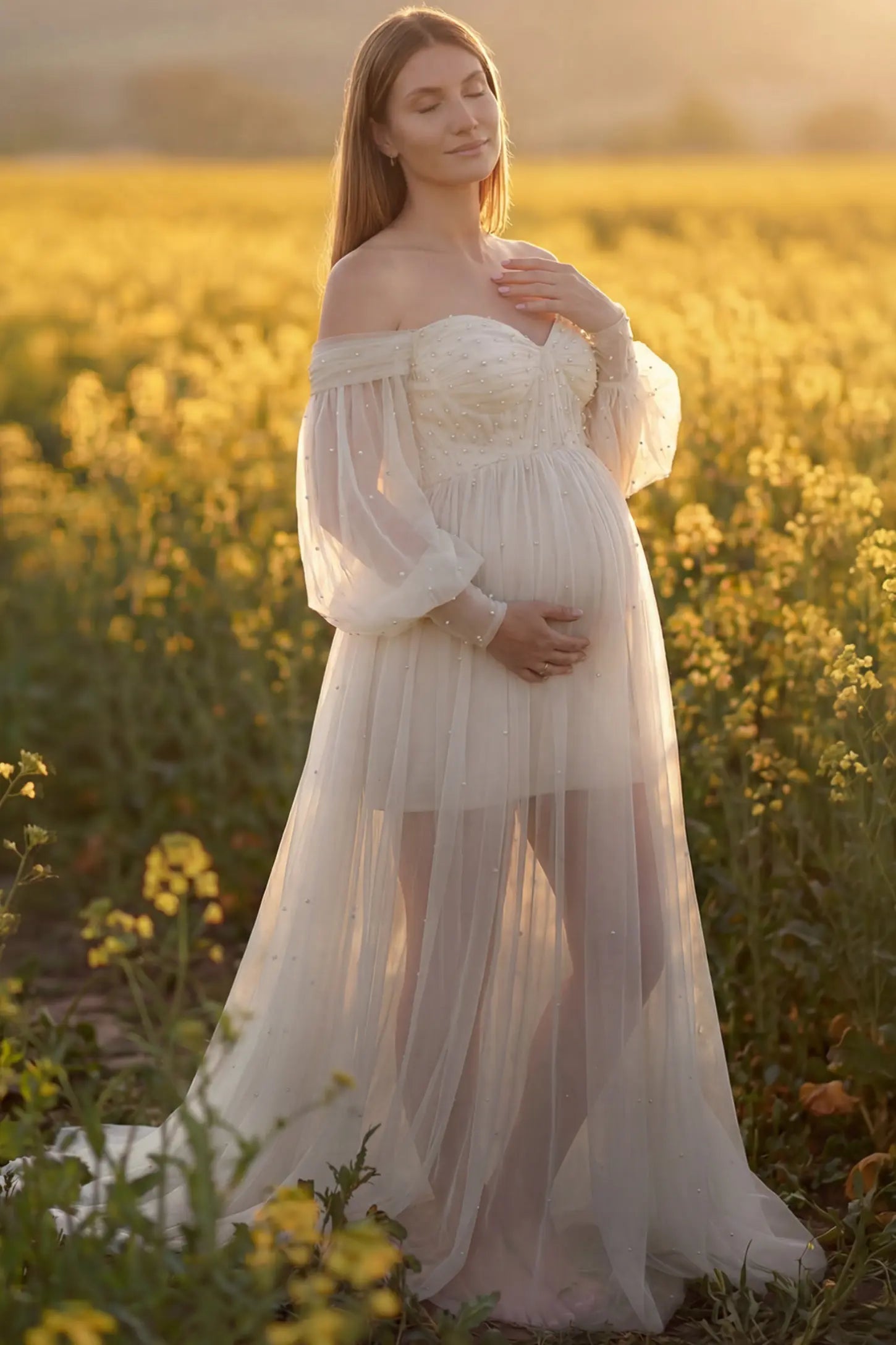 Off-Shoulder Empire Waist Maternity Gown in ivory featuring a sweetheart neckline and flowy A-line silhouette on a pregnant model, front view.