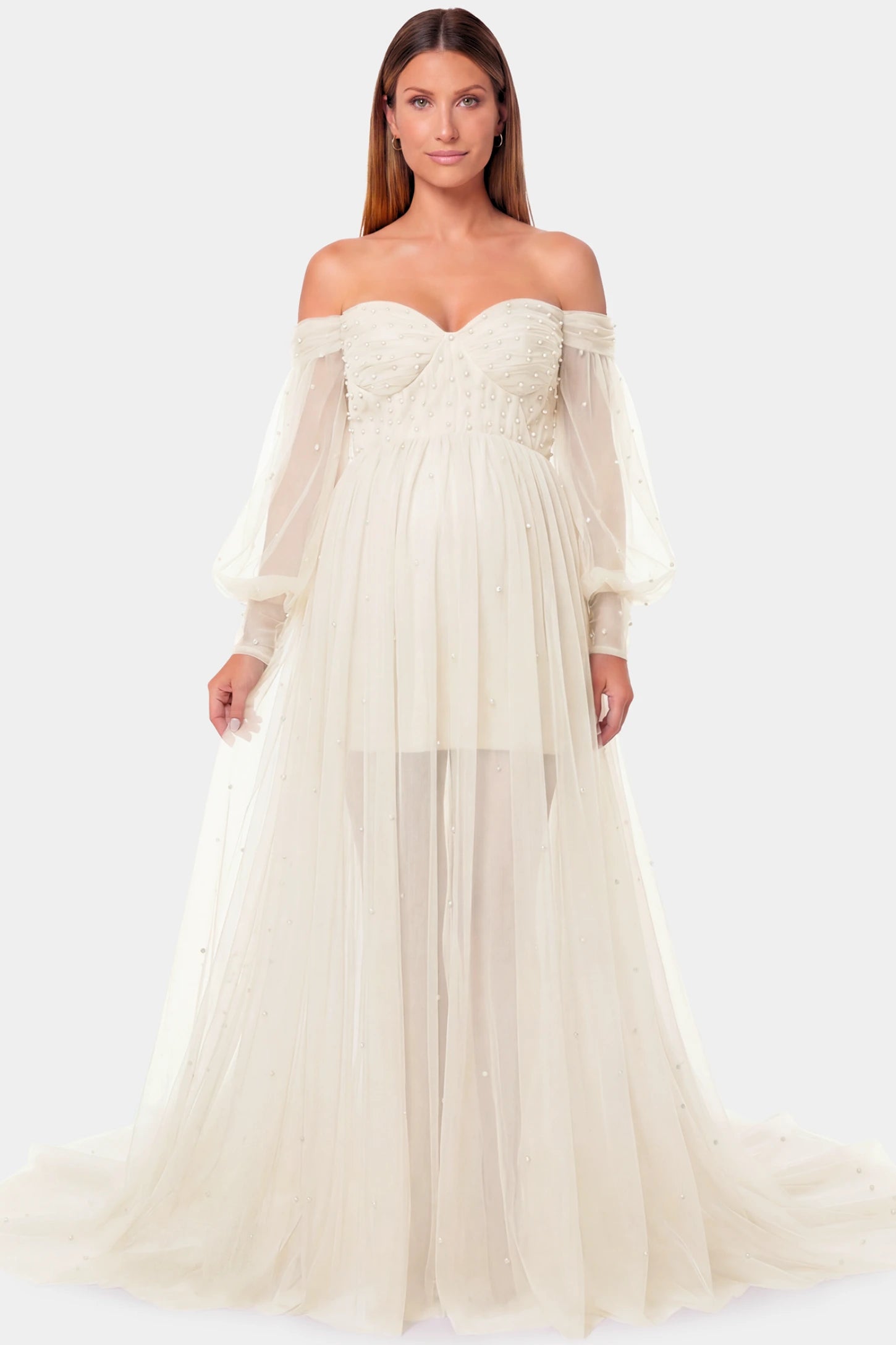 Off-Shoulder Empire Waist Maternity Gown Off-Shoulder Empire Waist Maternity Gown in ivory featuring a sweetheart neckline and flowy A-line silhouette on a pregnant model.