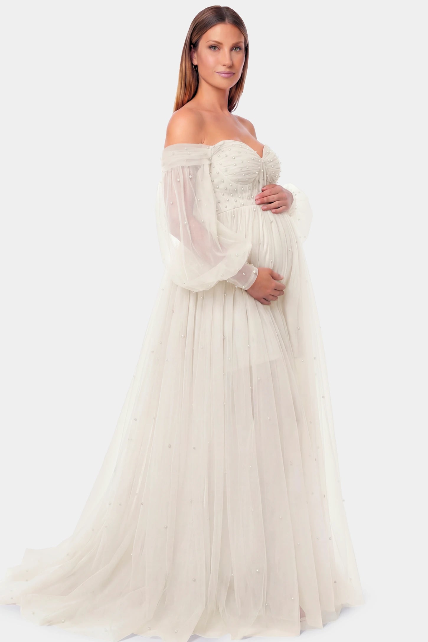 Off-Shoulder Empire Waist Maternity Gown Off-Shoulder Empire Waist Maternity Gown in ivory featuring a sweetheart neckline and flowy A-line silhouette on a pregnant model.