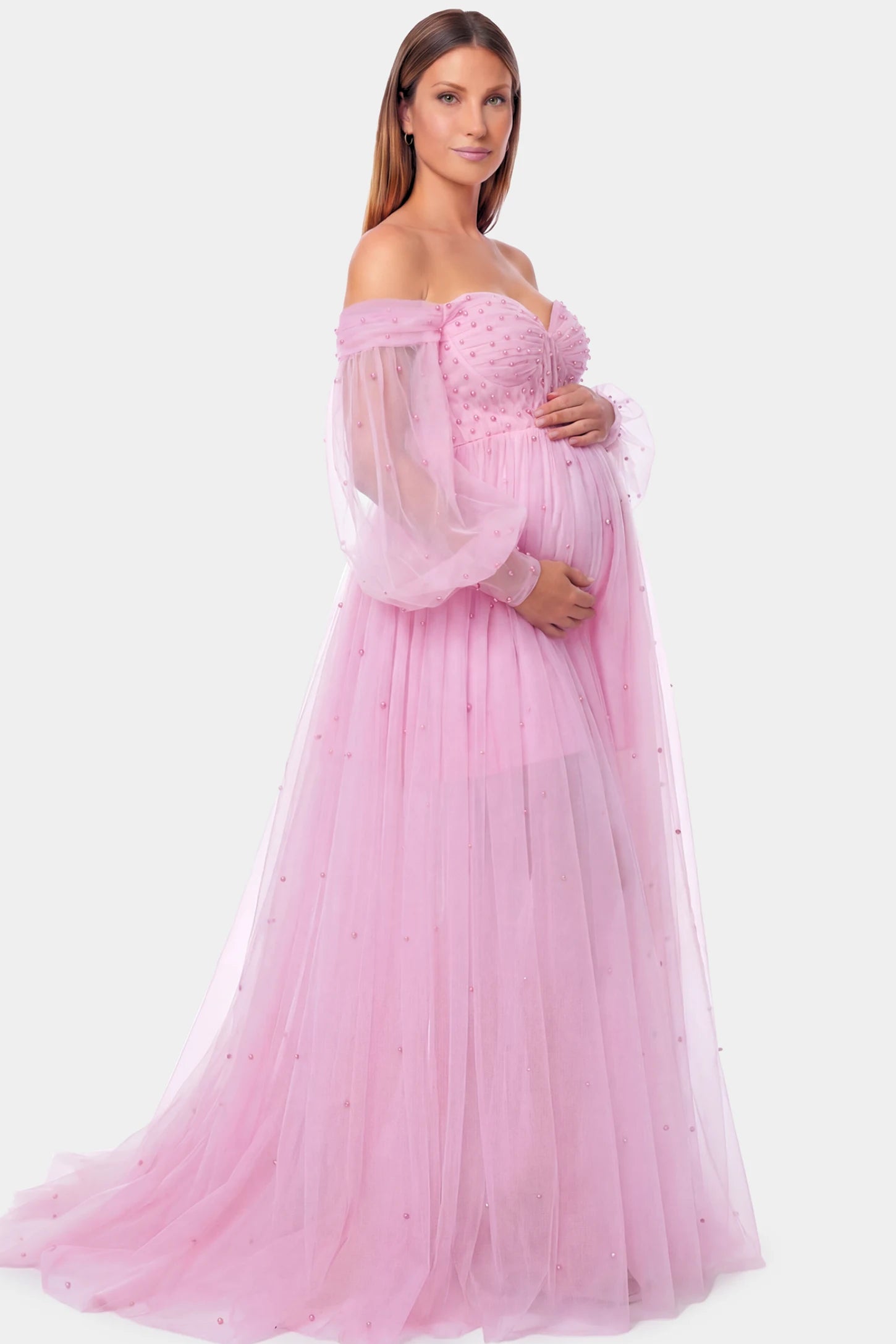 Off-Shoulder Empire Waist Maternity Gown Off-Shoulder Empire Waist Maternity Gown in pink featuring a sweetheart neckline and flowy A-line silhouette on a pregnant model.