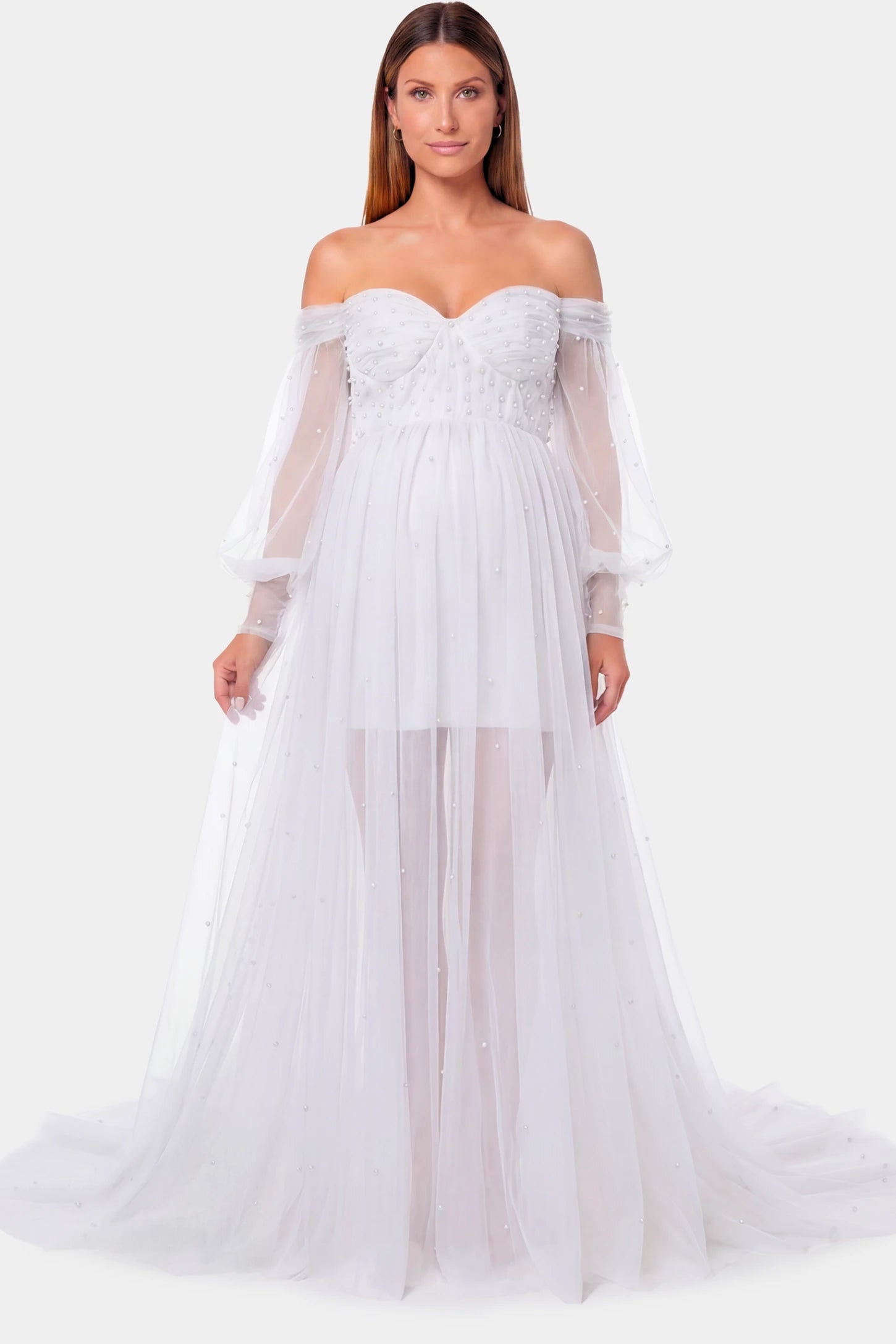 Off-Shoulder Empire Waist Maternity Gown Off-Shoulder Empire Waist Maternity Gown in white featuring a sweetheart neckline and flowy A-line silhouette on a pregnant model.